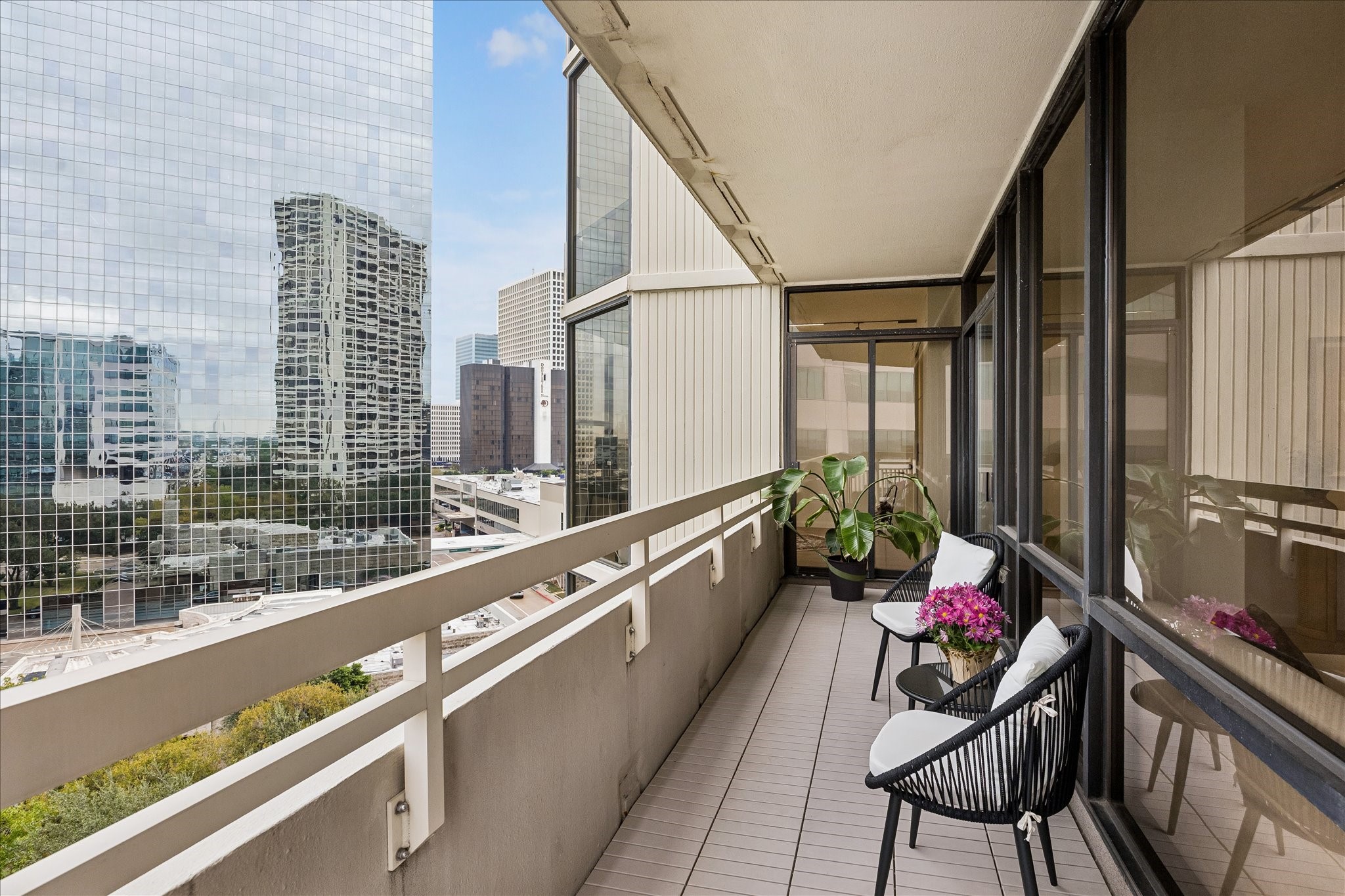 Balcony extends alongside the living room windows and connects to the corner bedroom.