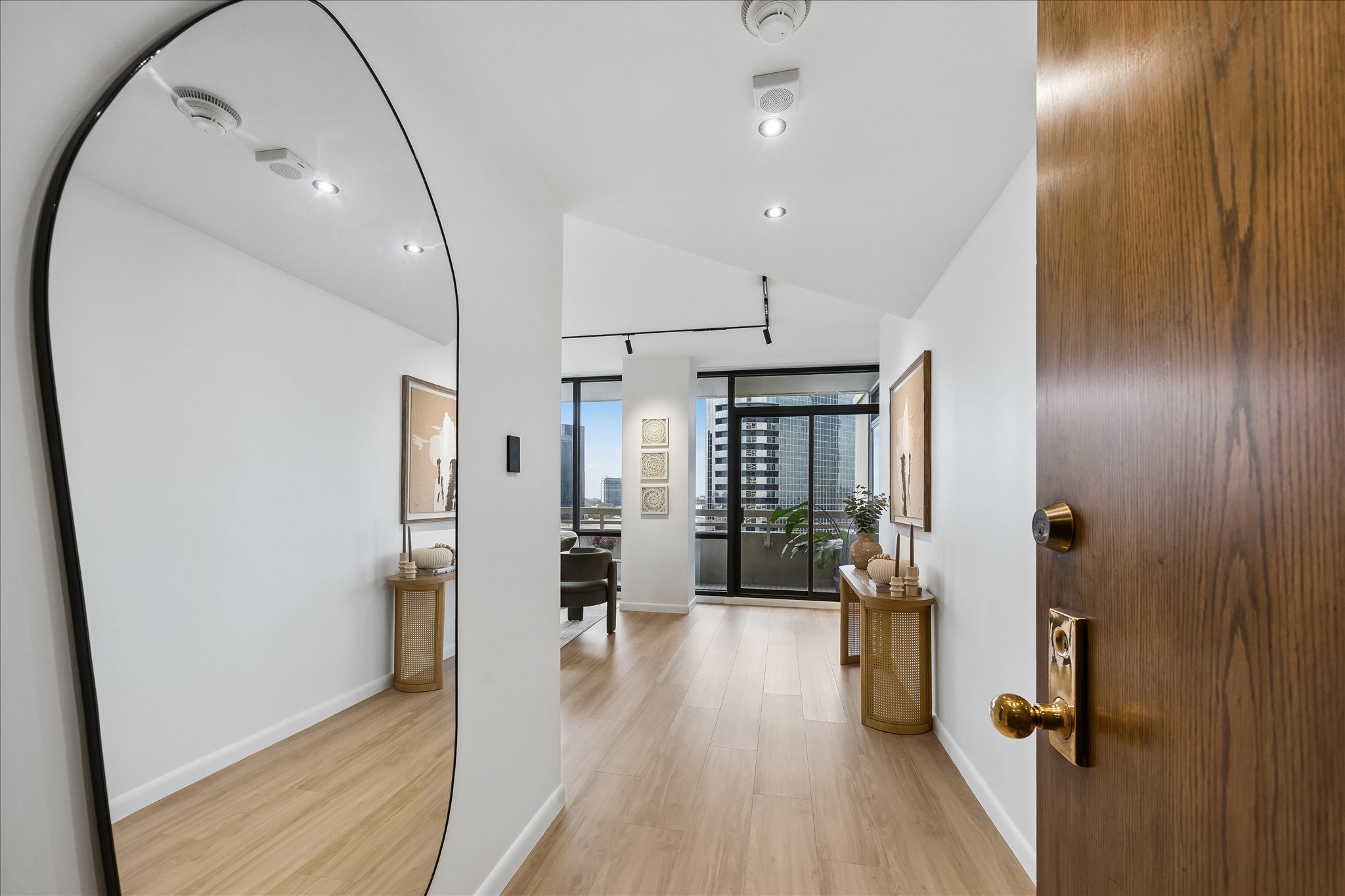 Foyer opens toward the living room and covered balcony.