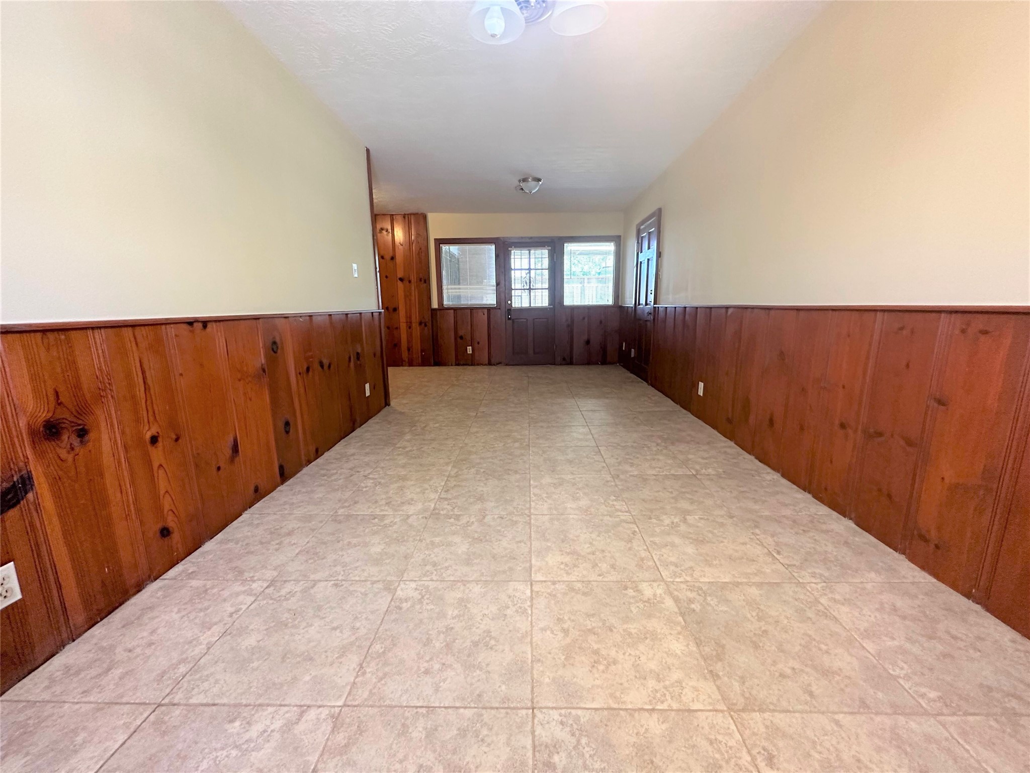 Another view of the huge dining room showing door/windows out to back covered patio.  Breakfast room to left and garage access to right.