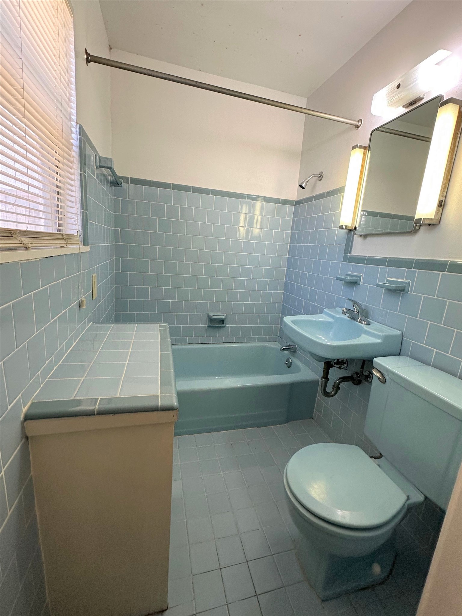 How fun is this retro look?!  This is the primary bathroom with tub/shower combo and built-in storage/vanity.