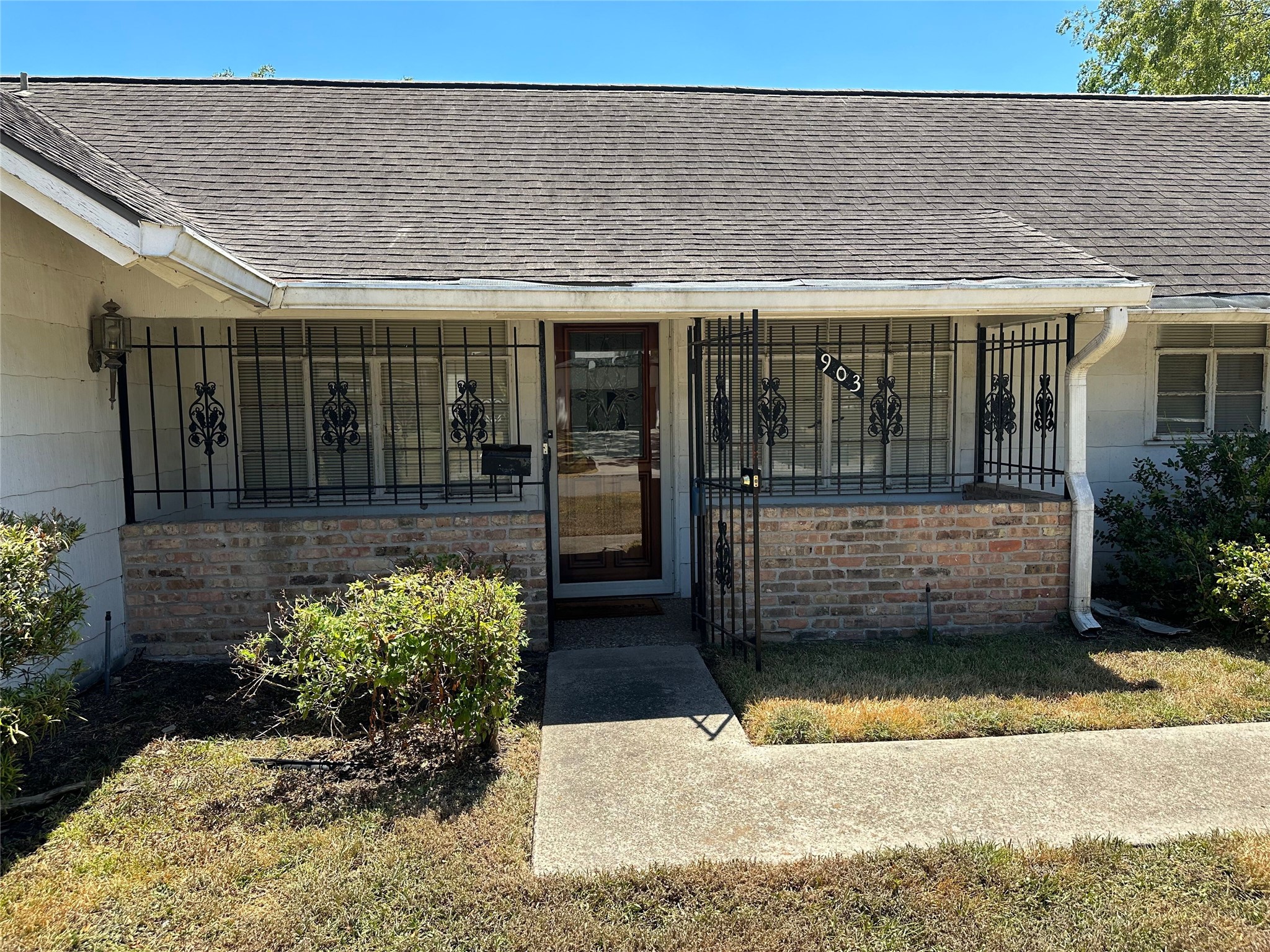 Front porch with locking iron gate and storm door. Front porch with locking iron gate and storm door.