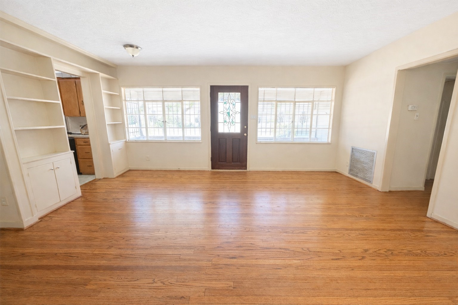 View of front entrance/living room. Large windows and leaded glass door offer plenty of natural light and welcoming feel. View of front entrance/living room. Large windows and leaded glass door offer plenty of natural light and welcoming feel.