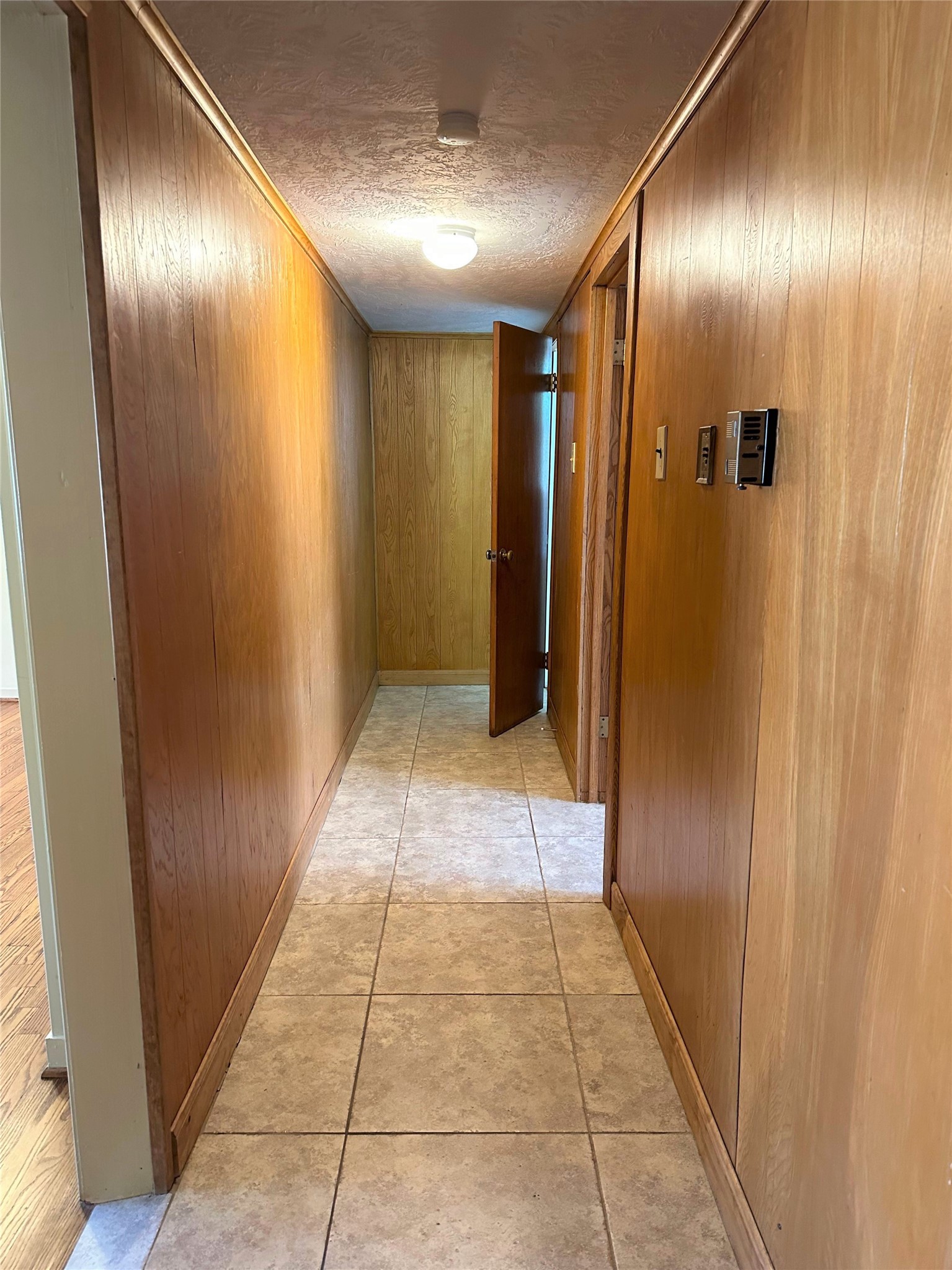 Hallway between the two living areas leads to the primary bedroom and bath.  Primary suite is separated from secondary bedrooms/bath offering additional privacy.