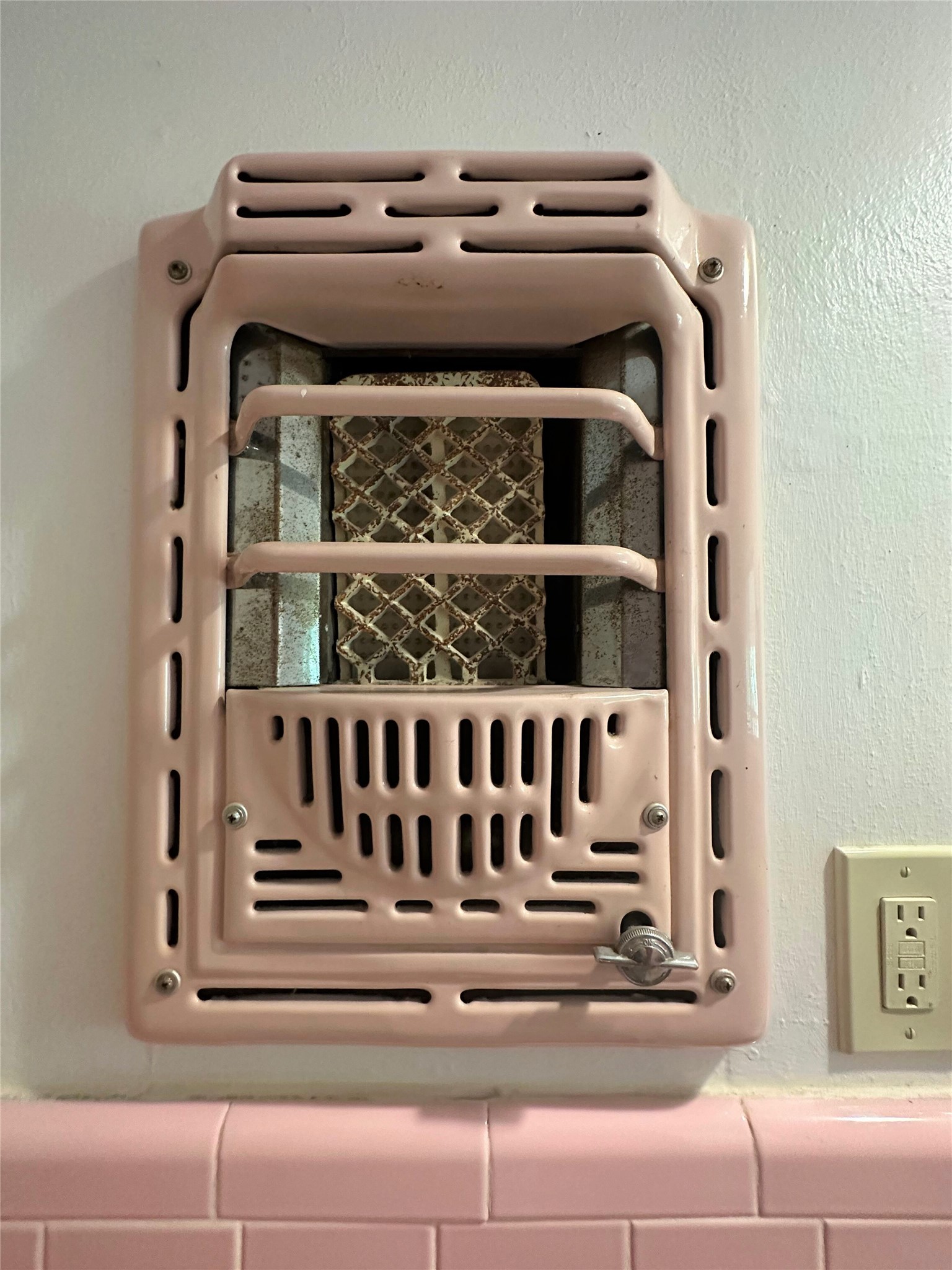 Wall art from the 1940's!  Love that they kept this wall heater in place after upgrading to central heating. Adds so much character!