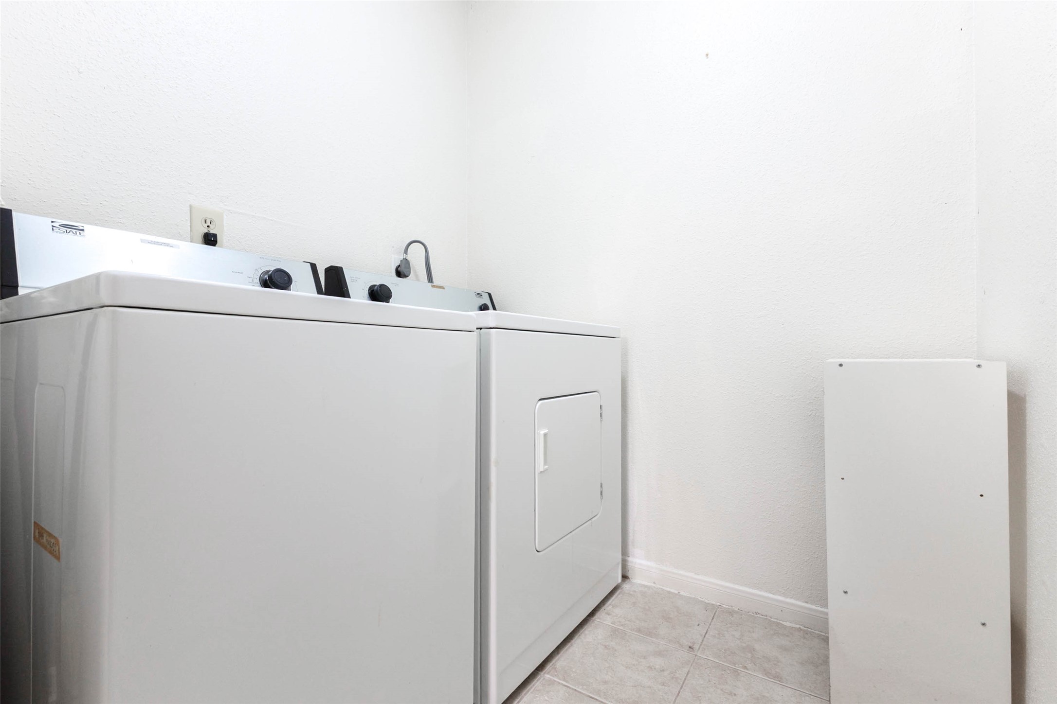 Dedicated interior laundry area with washer and dryer, conveniently located within the home.