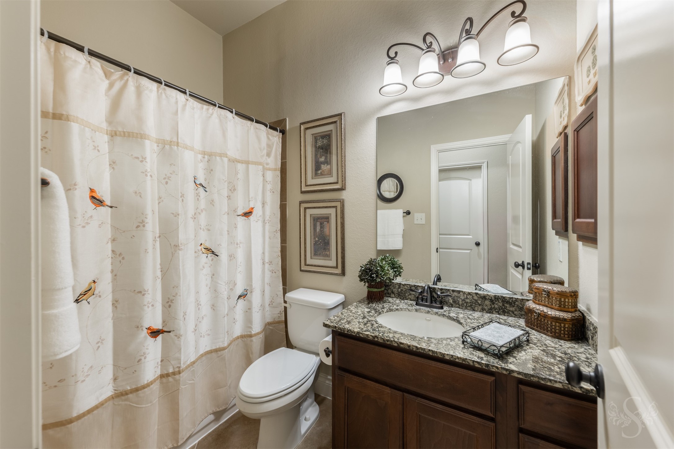 The full bath downstairs features a beautiful granite vanity and richly stained cabinetry that complement the homes style. A tub and shower combination provides everyday convenience.