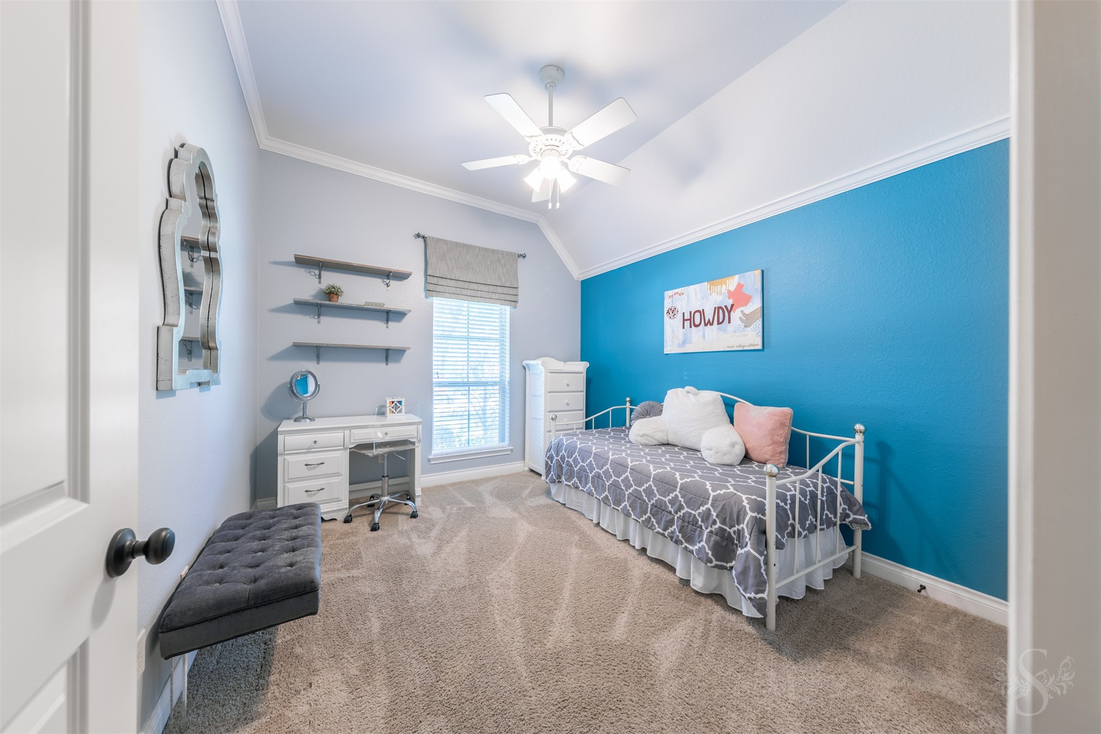 A high, angled ceiling gives this charming secondary bedroom an airy feel, while a tall window brightens the space. There is ample room for a cozy bed and a desk, creating a welcoming place to rest, study and enjoy quiet time.