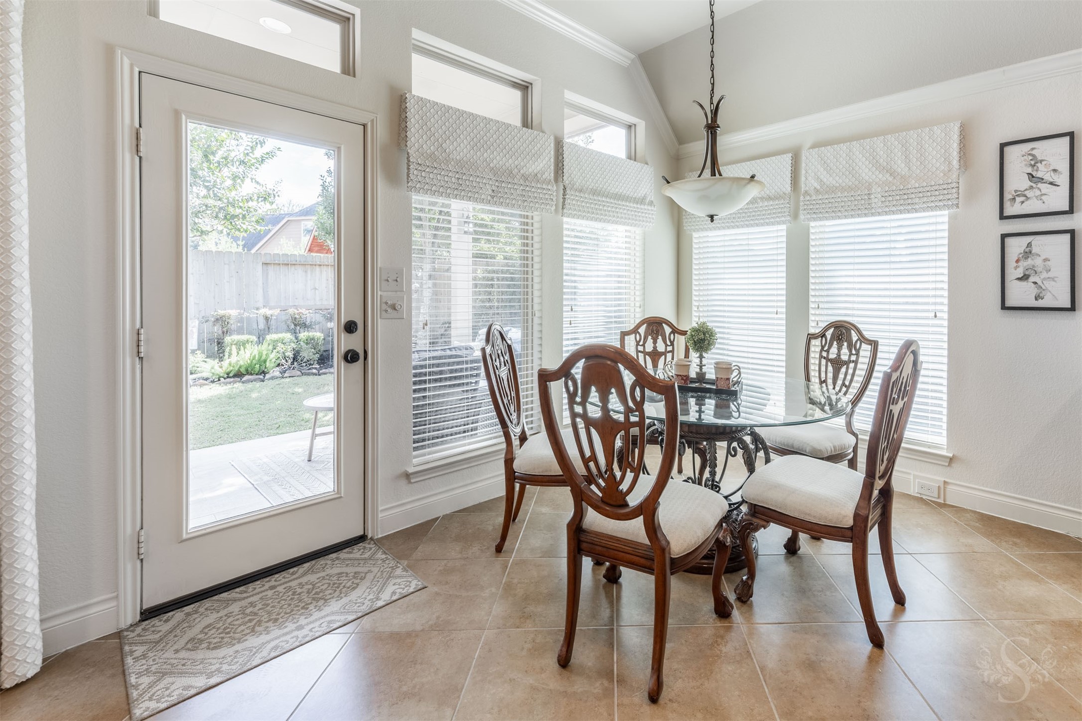 Surrounded by tall windows, the breakfast room offers a cheerful, bright place to start your day with morning coffee and views of the beautifully landscaped backyard. A glass door opens to the covered patio for leisurely breakfasts in the fresh air.
