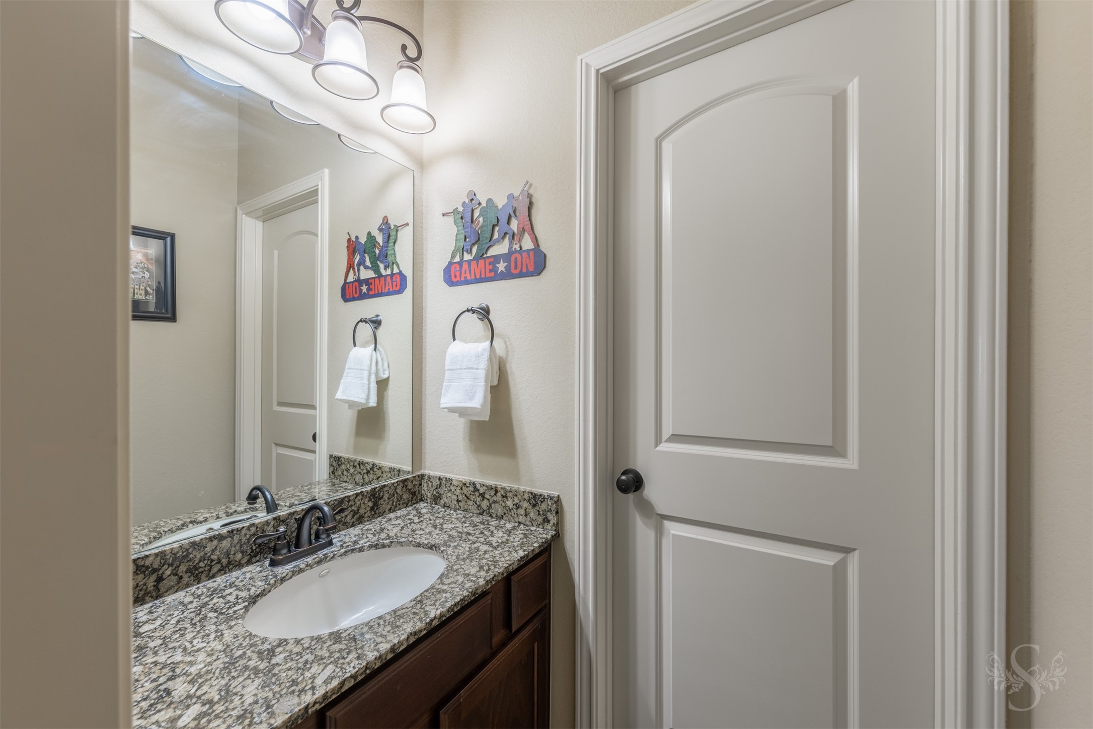 The Hollywood bath features a granite vanity and richly stained cabinetry for an elegant, polished look. A separate vanity area makes busy mornings easier while providing added privacy.