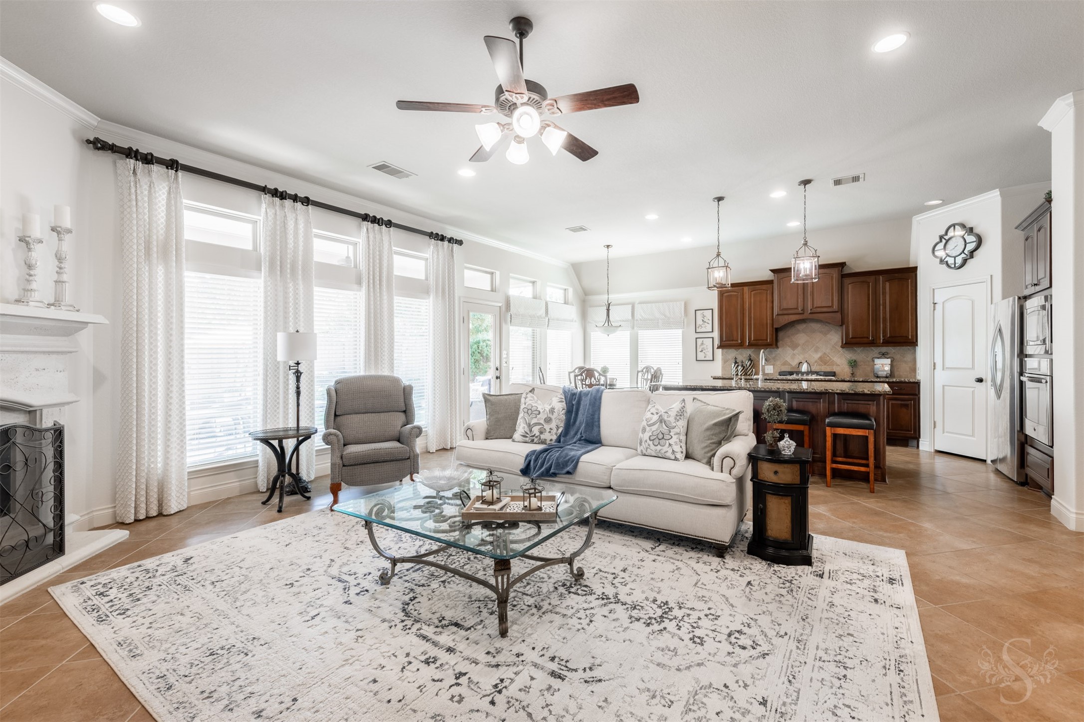 The spacious family room opens to the kitchen and breakfast room, creating a generous gathering area designed for family time and entertaining friends. Tall windows span the back of the home, bringing a bright, inviting feel to this elegant open concept floor plan.