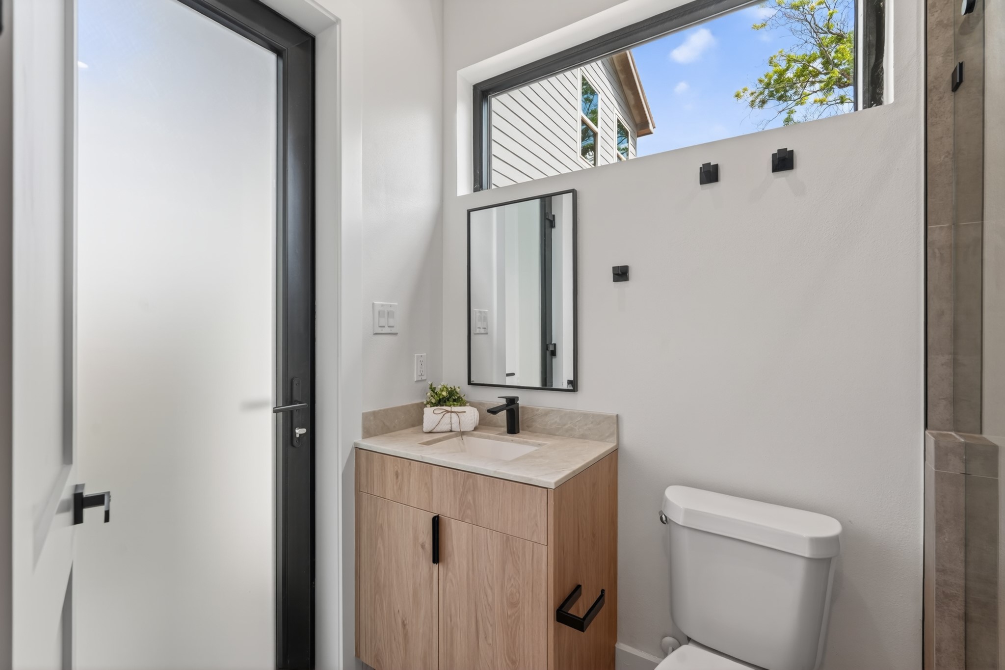 Private guest bathroom with convenient access to the covered patio, providing easy use for outdoor gatherings without needing to access the main living areas.