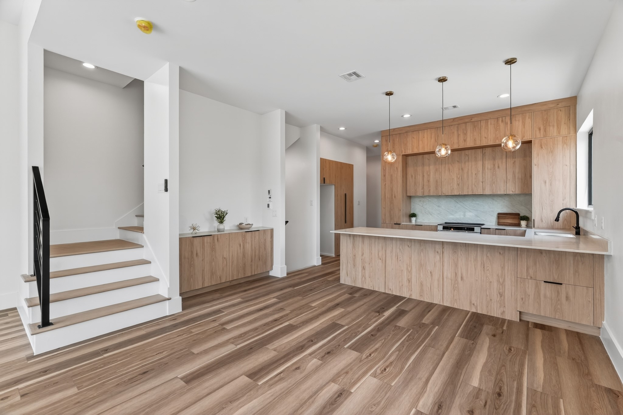 Every detail of the kitchen was thoughtfully designed with functionality in mind, featuring semi-custom cabinetry that maximizes storage while making efficient use of every inch of space throughout the home.