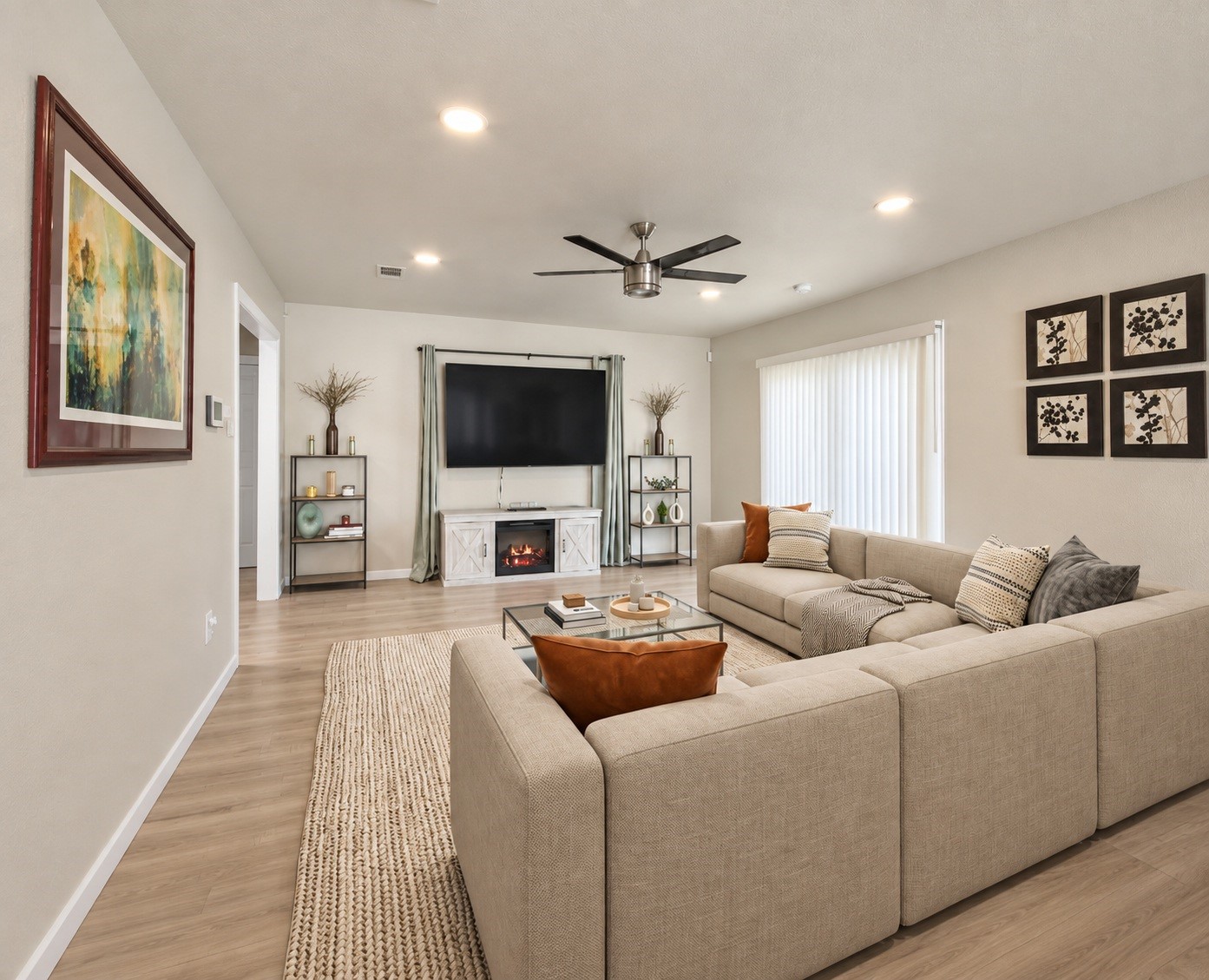 The living area features recessed lighting, a ceiling fan, and a new sliding glass door that fills the room with natural light. Virtually staged.