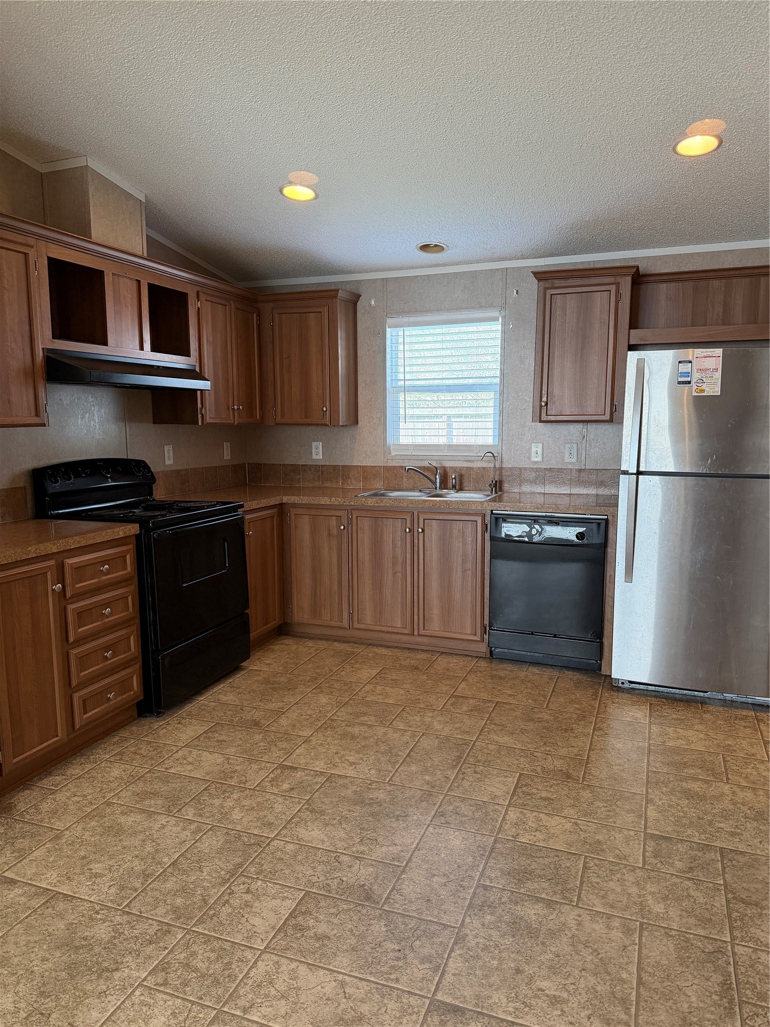 Modern kitchen with abundant cabinet storage, spacious countertops, and a practical layout perfect for meal preparation and family gatherings.