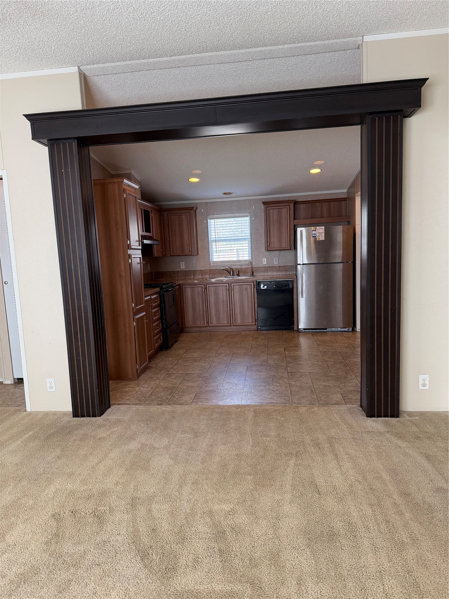 Bright and spacious living room with an open floor plan, large windows, and plenty of room for gathering with family and friends.