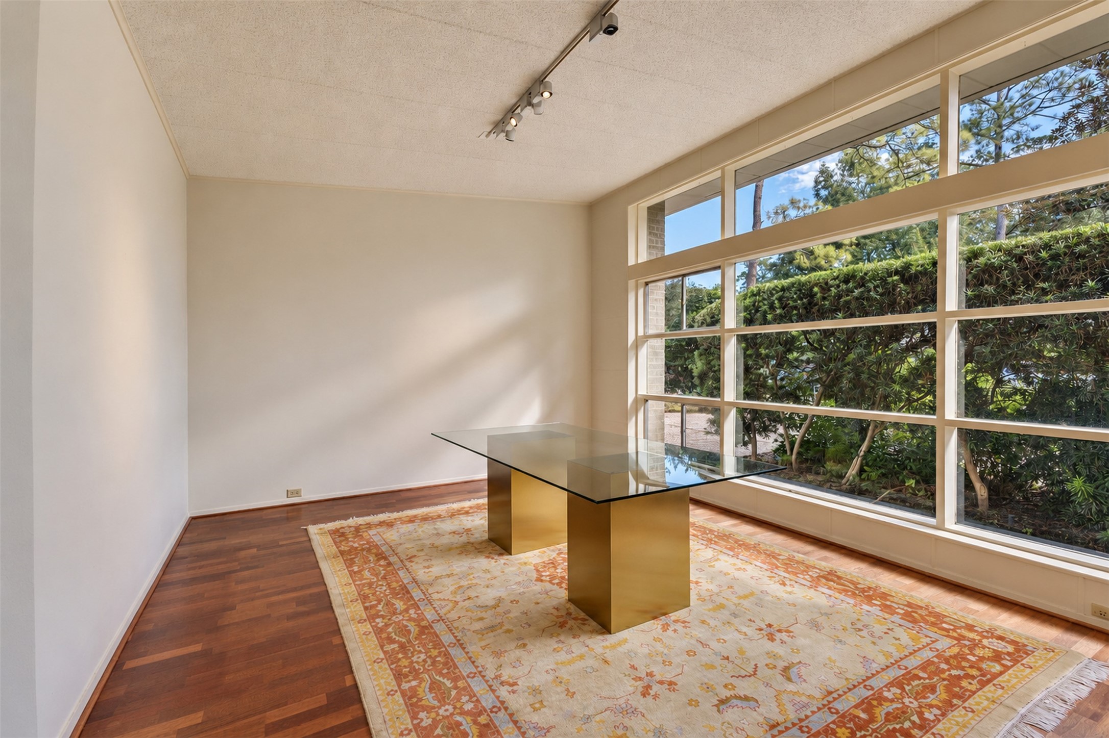 The dining room is framed by the enormous floor to ceiling window.