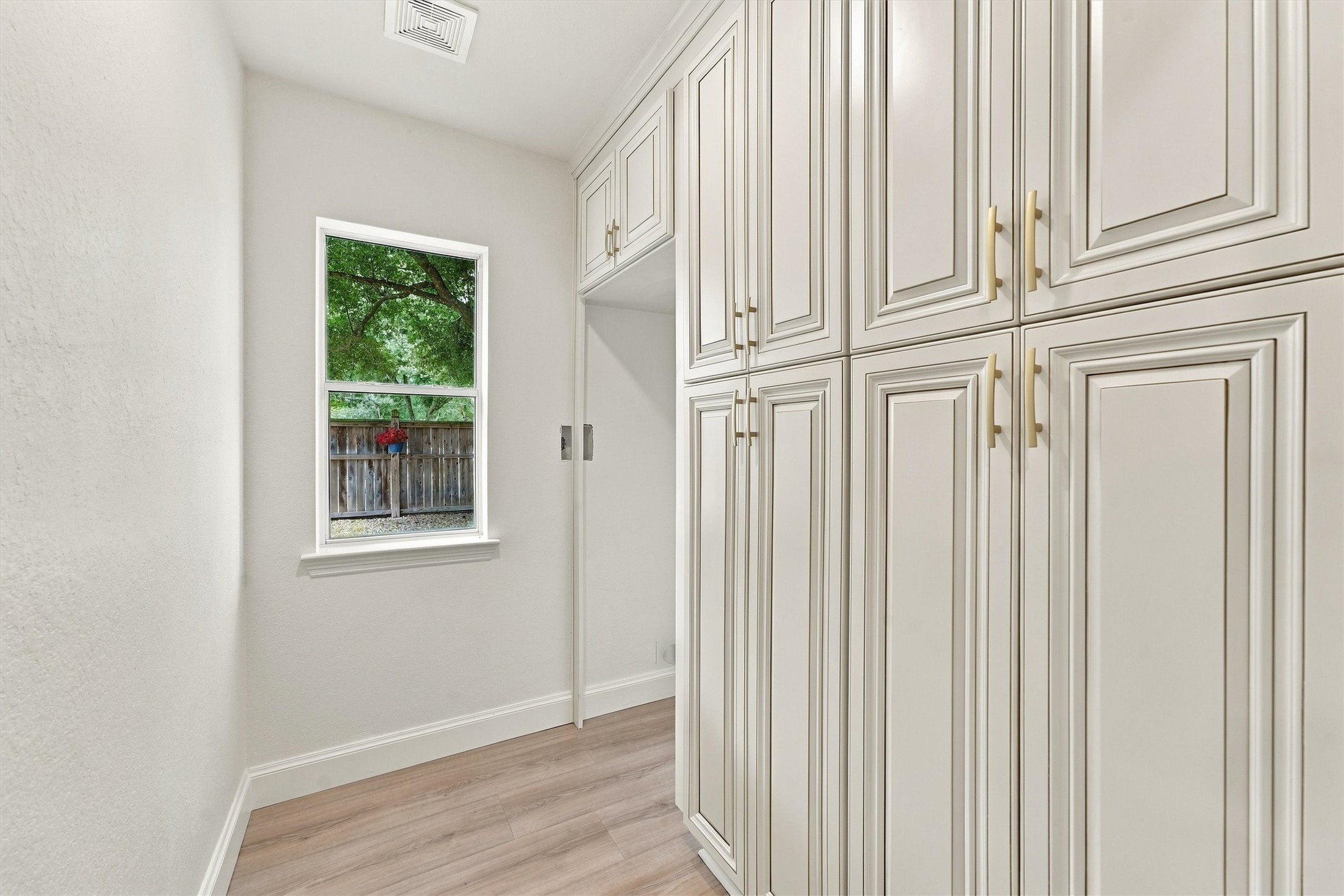 Primary bedroom (down) - custom closet built in cabinets with abundant cabinet storage.