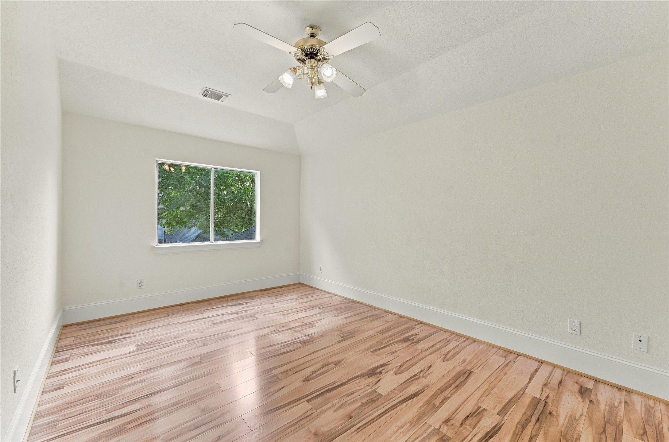 Second floor - Fifth bedroom with vaulted ceiling and wood floors.