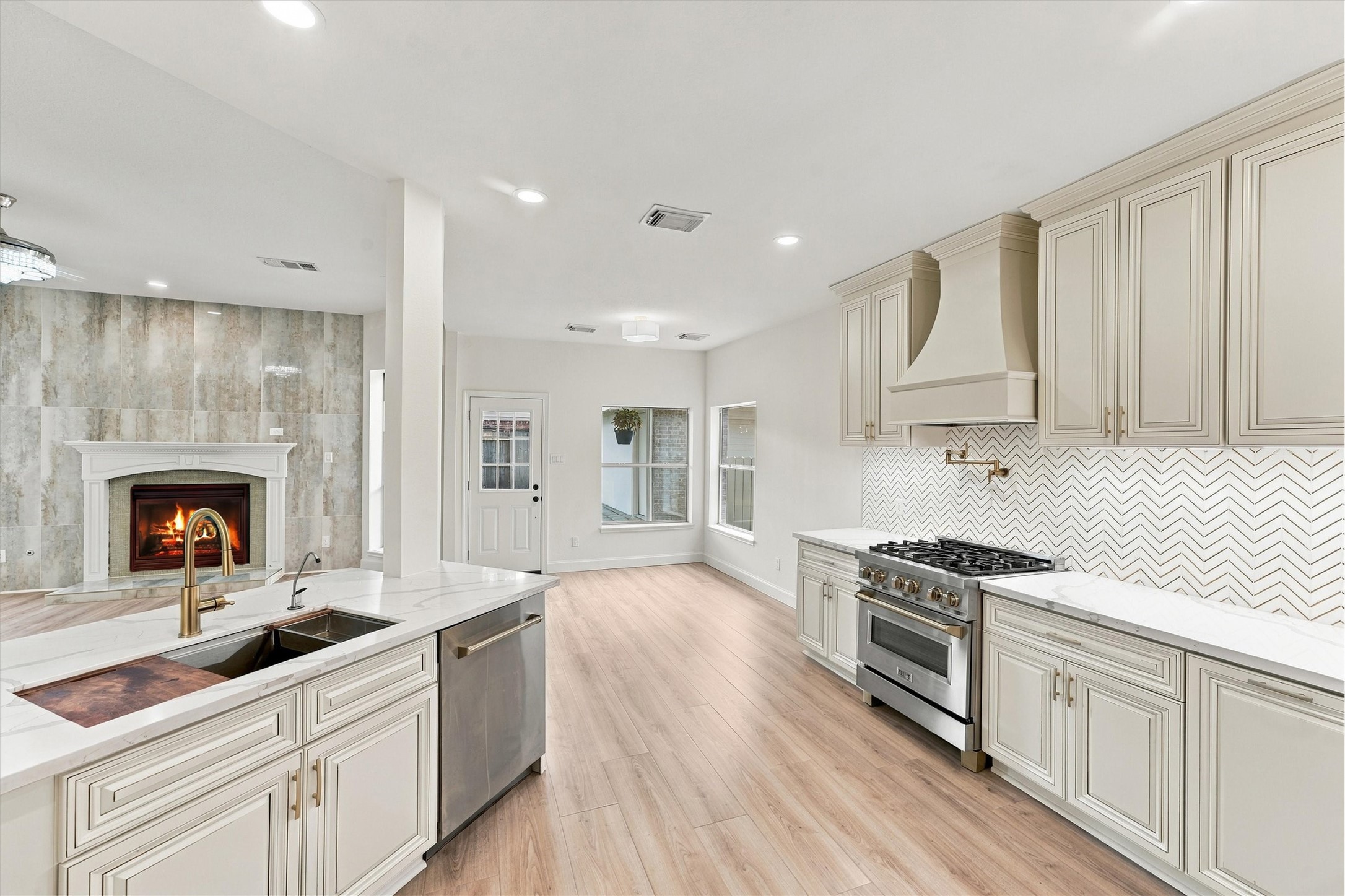 Quartzite countertops and chevron white / gold custom tile backsplash.