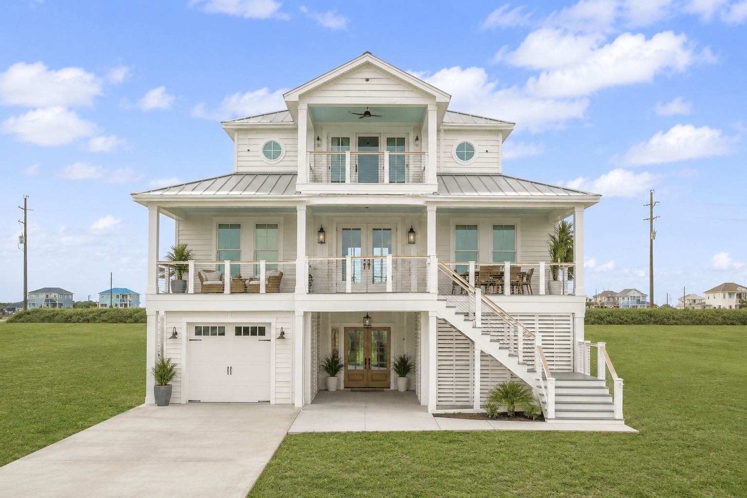 Virtual example showing what could be built on the lot, with an elevated coastal design, broad front porches, and a light exterior palette suited for the Galveston setting. A helpful visual for imagining the scale, style, and beach-house potential of the homesite.