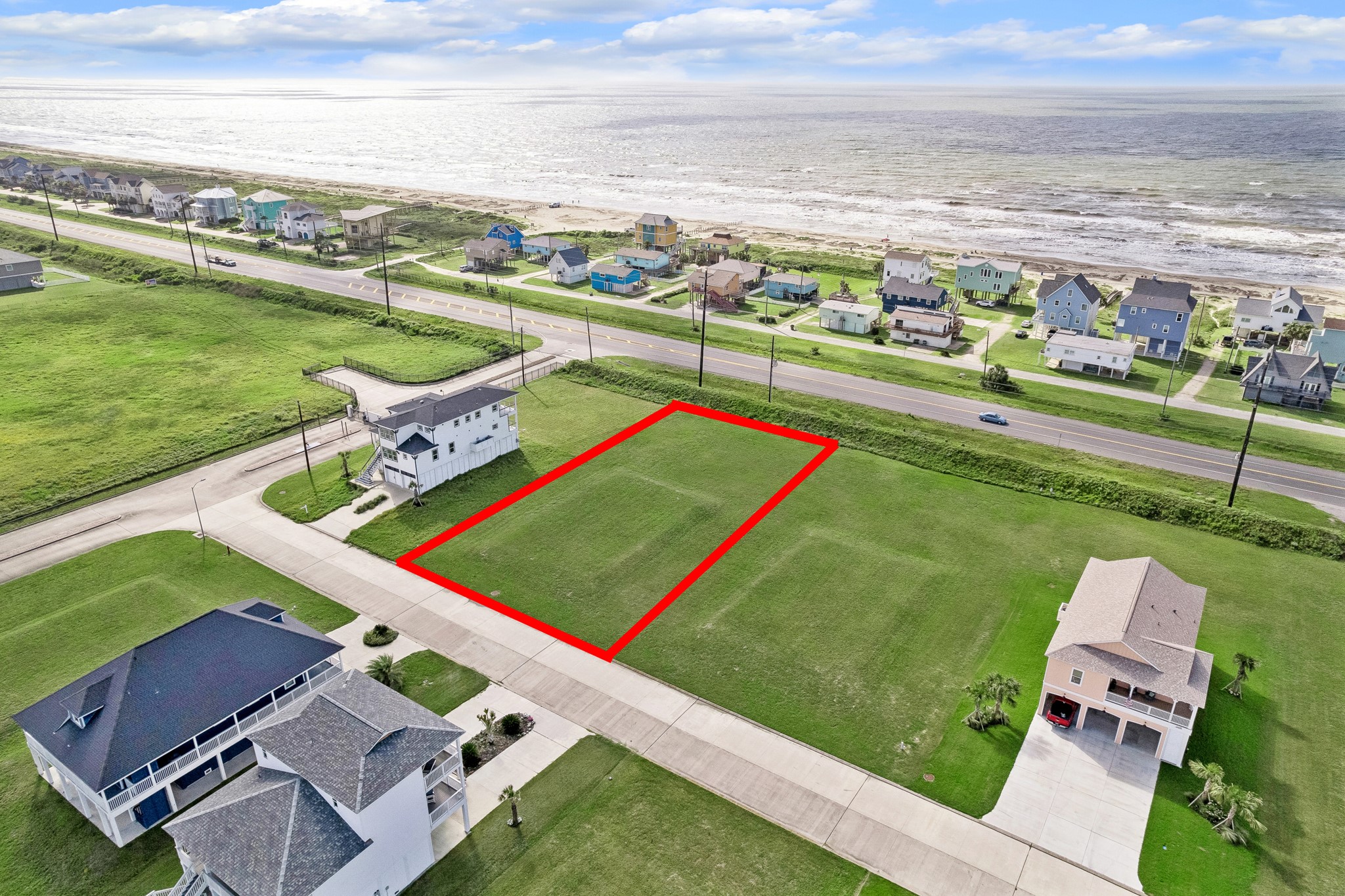 Framed by finished coastal homes, this lot enjoys a quiet interior position while the beach stretches across the horizon.