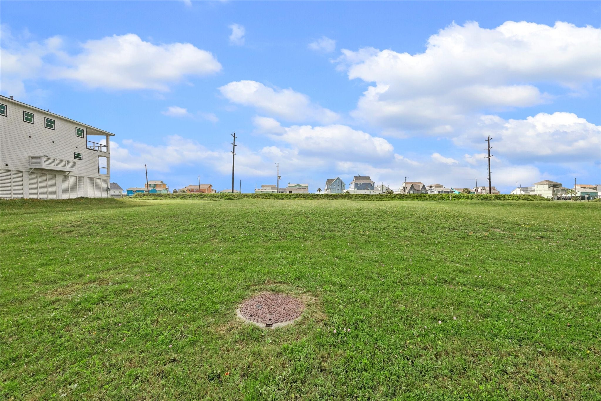 At ground level, the grassy expanse shows off its generous width and gentle, buildable grade.