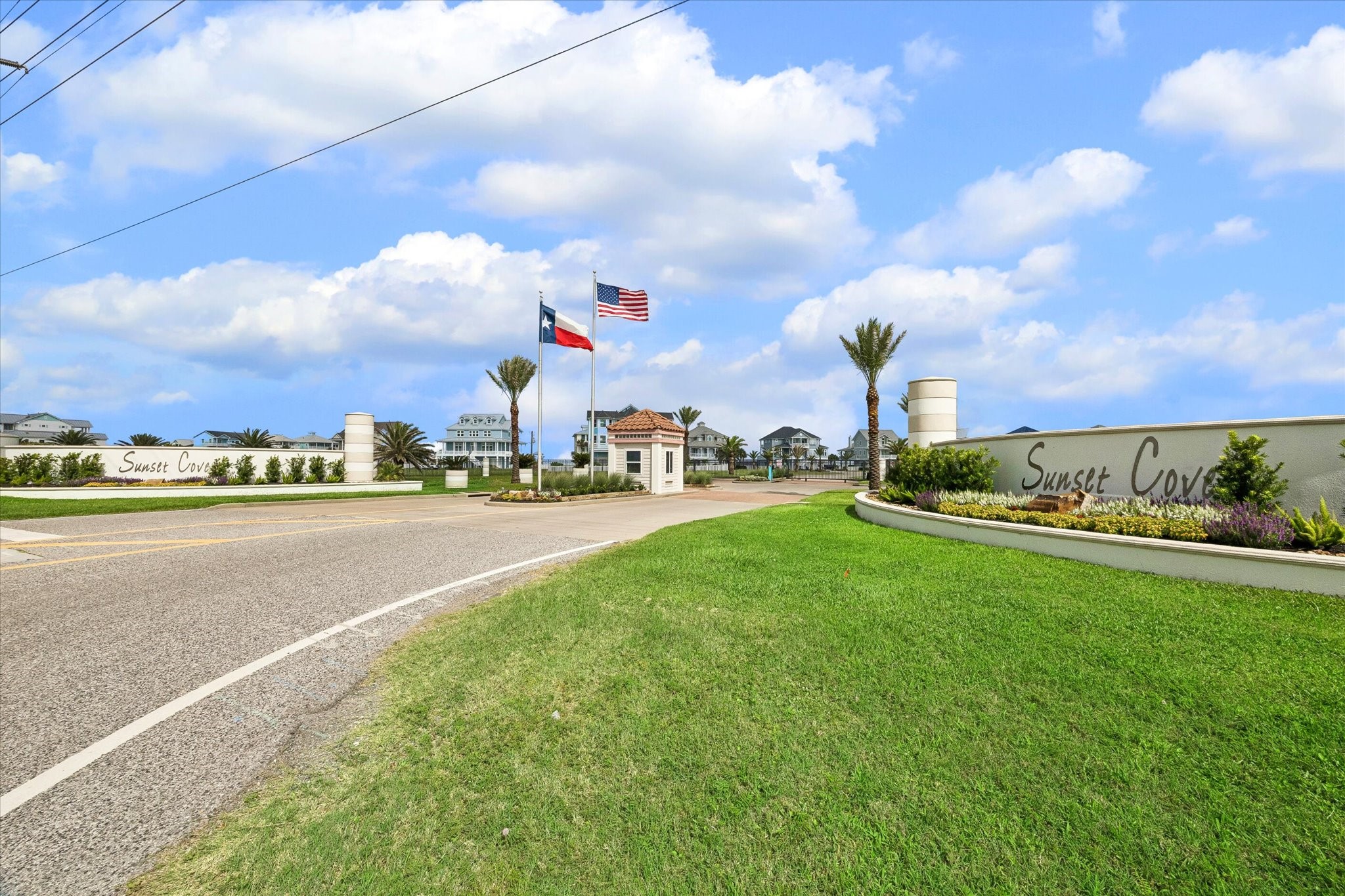 The Sunset Cove entrance sets the tone with gated access, landscaped signage, and a polished coastal arrival. Palm-lined streets lead into a private neighborhood designed around water access and relaxed beachside living.