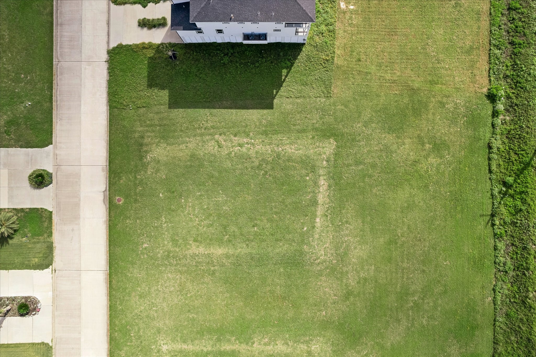 Cleared and level from above, the lot offers a clean canvas for your custom floor plan with room to spare on every side.