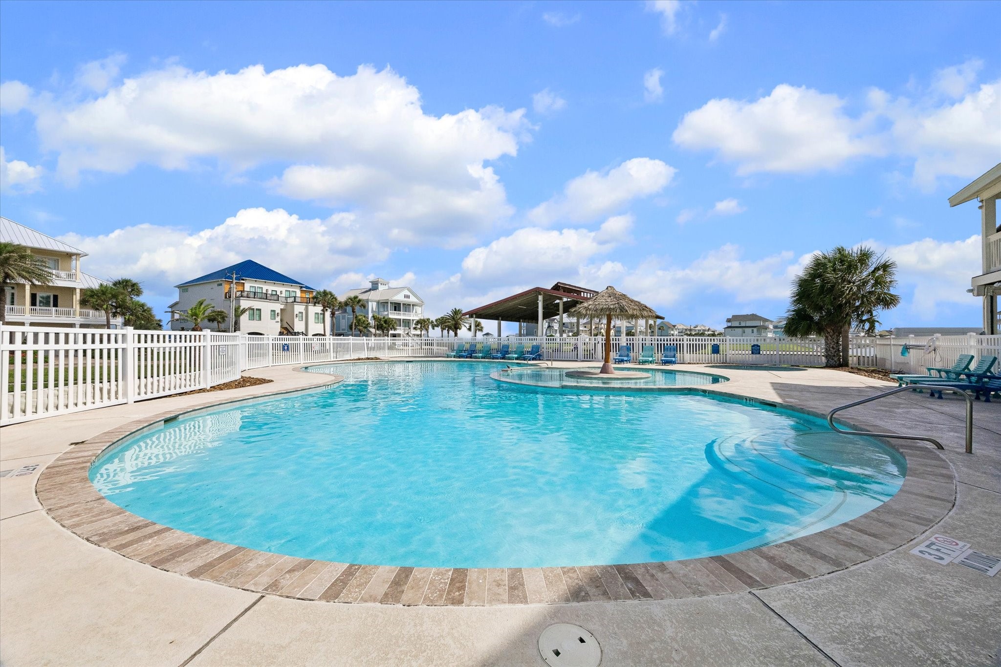 Community pool access brings a true resort feel to Sunset Cove, with lounge seating, shaded gathering space, and palm-lined surroundings. An easy spot to cool off after a day at the beach or enjoy a relaxed afternoon close to home.