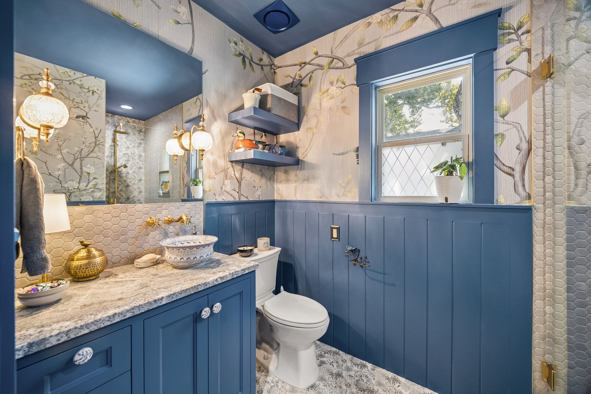 Unbelievably blue 2nd full bathroom remodel. The tile and wallpaper match, making it feel like you're by the ocean.