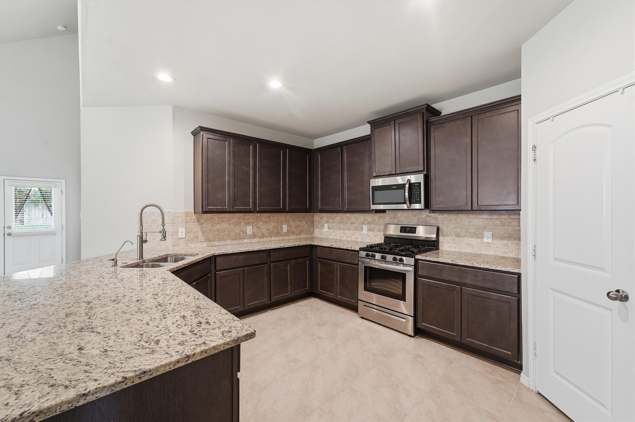 Open concept kitchen with granite countertops. Open concept kitchen with granite countertops.