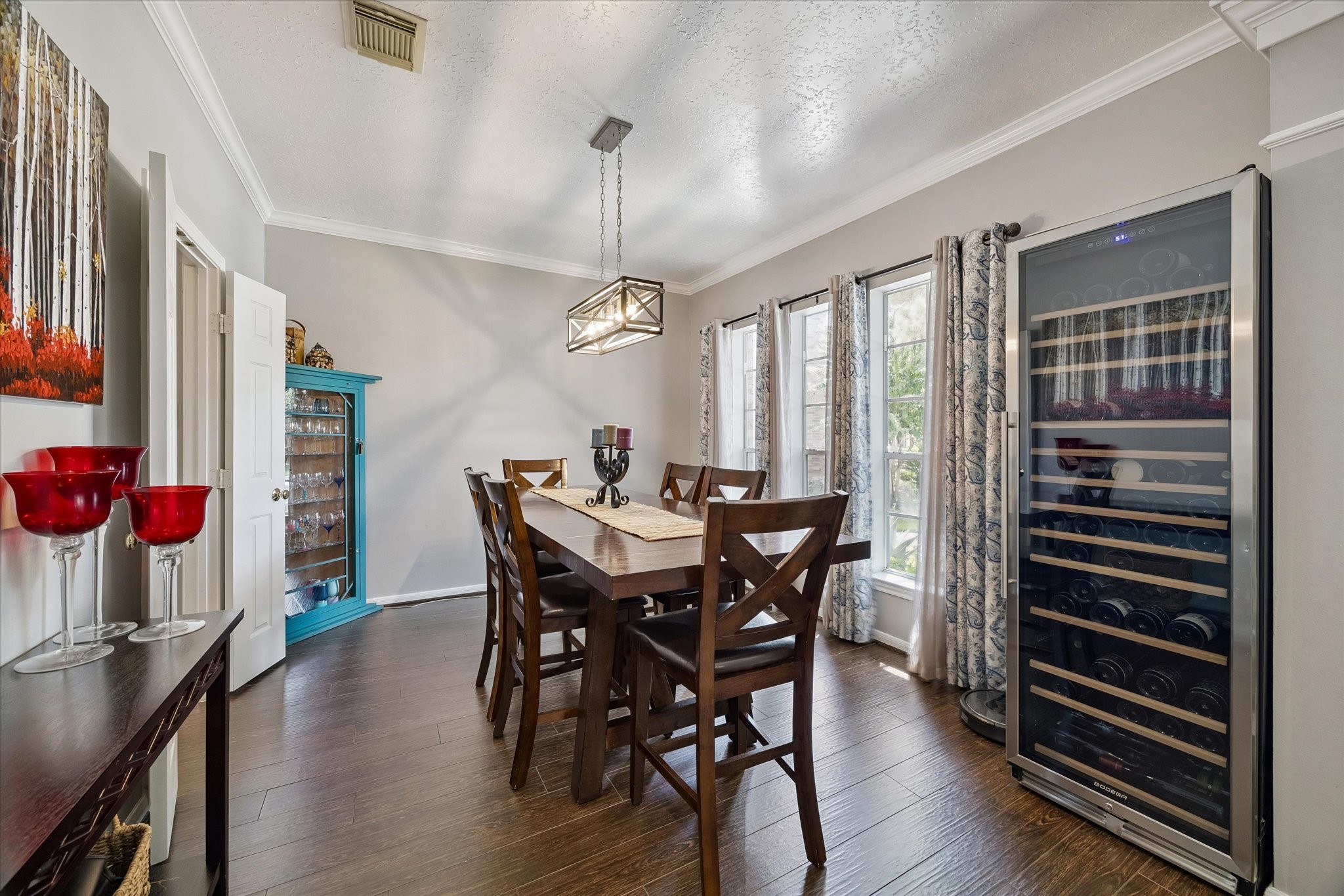 Formal dining area has natural light and crown molding.