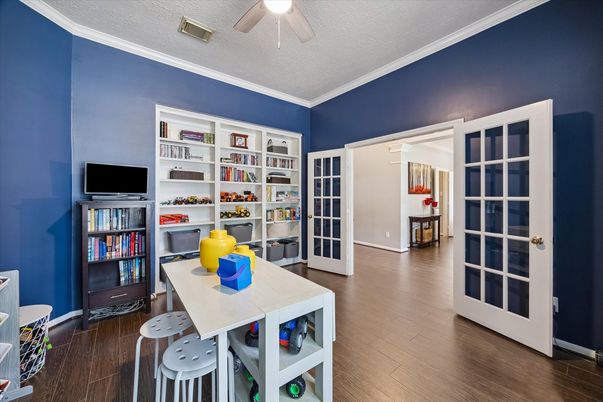 The office showcases crown molding and built-in bookcases and can easily be used as a flex space for your needs.