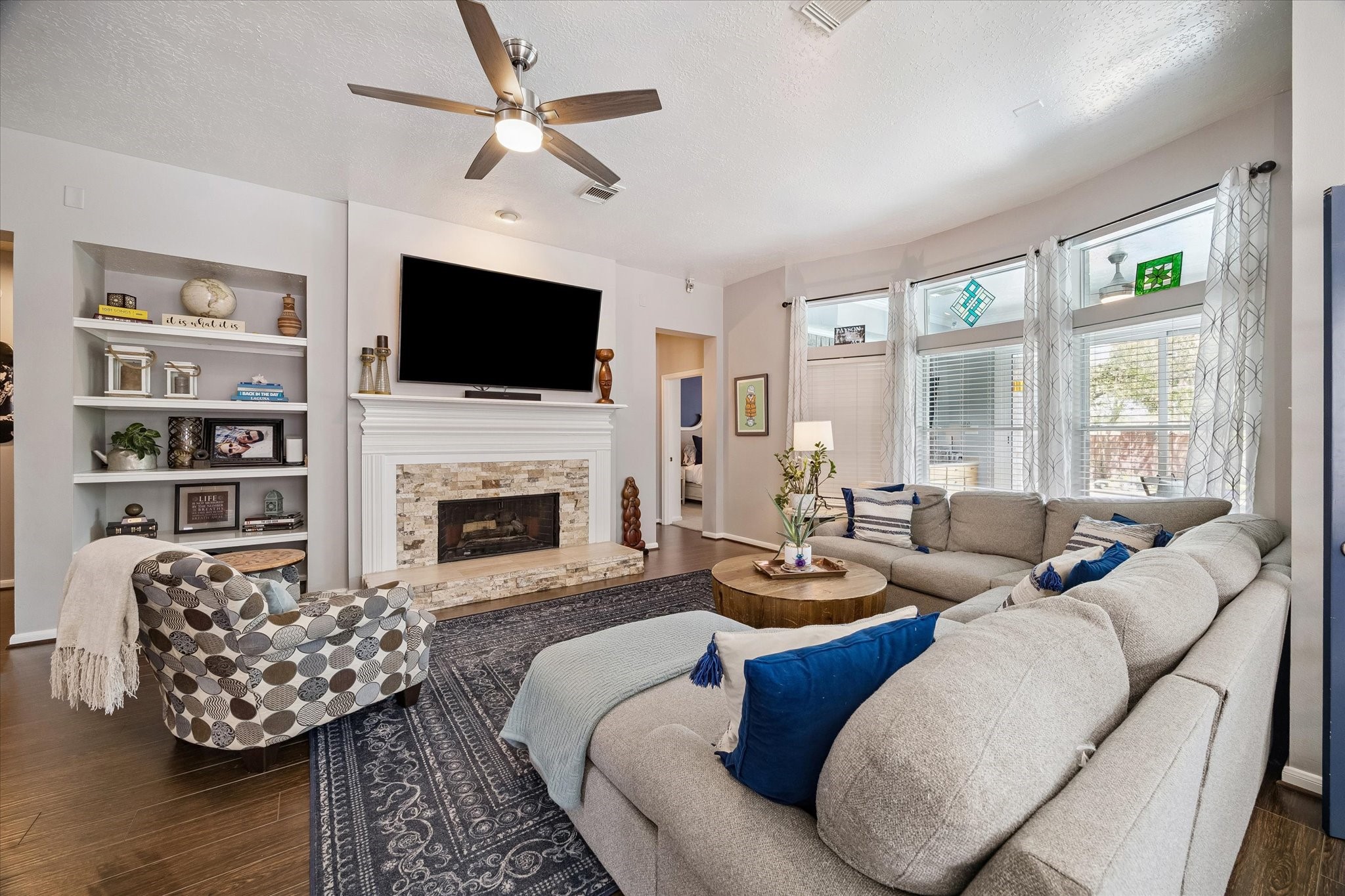 The formal living area is spacious, provides natural light and boasts a gas fireplace.