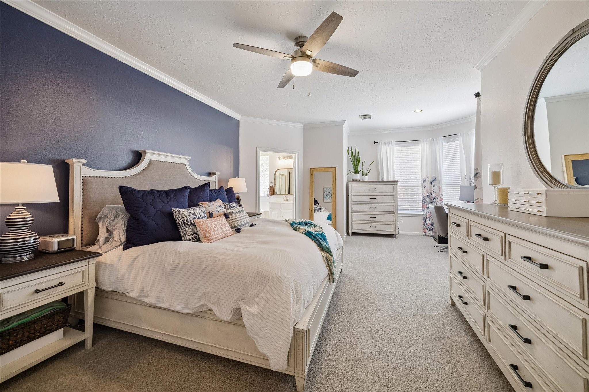 In the primary bedroom you'll find a wrap around, walk-in closet, crown molding and ample space. It also provides a reading nook / alcove area.