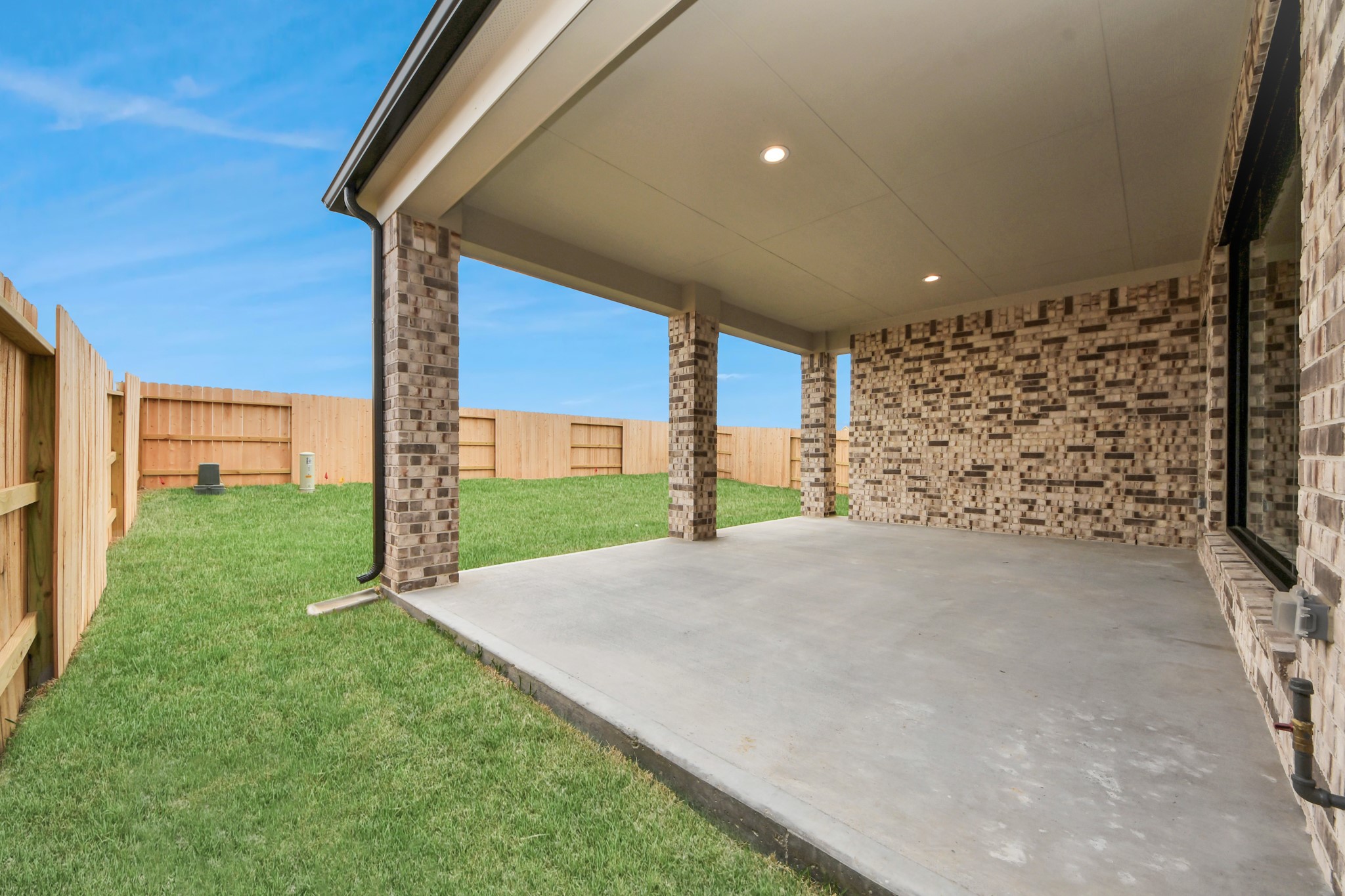 Experience outdoor living at its finest on this expansive covered patio, thoughtfully designed for BBQs and delightful outdoor dining. Sample photo of completed home with similar floor plan. Actual colors and selections may vary.