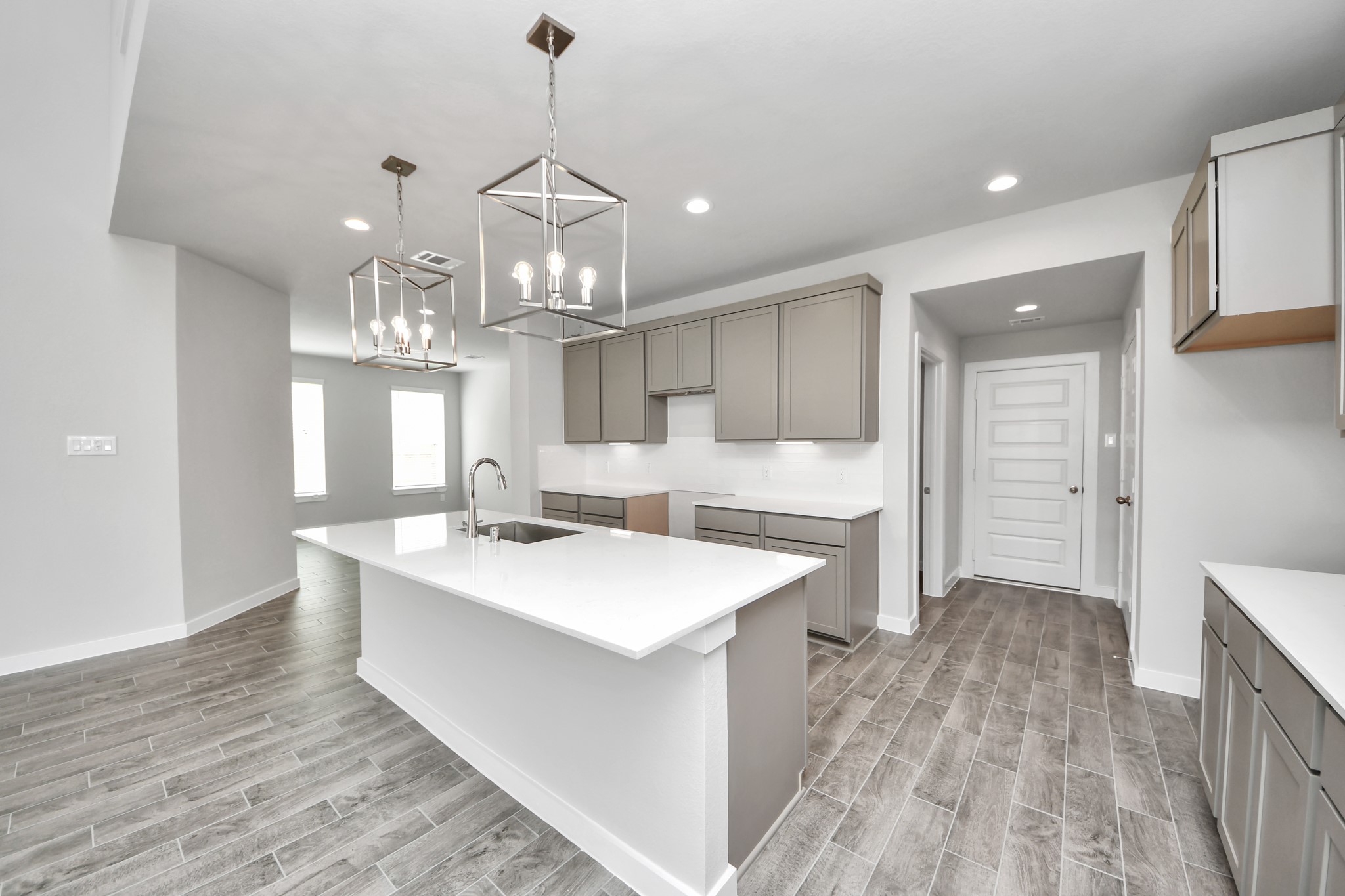The extended counter area adds both practicality and style, making meal preparation a breeze. Every detail is thoughtfully designed to enhance the kitchen's functionality and aesthetic appeal. Sample photo of completed home with similar floor plan. Actual colors and selections may vary.