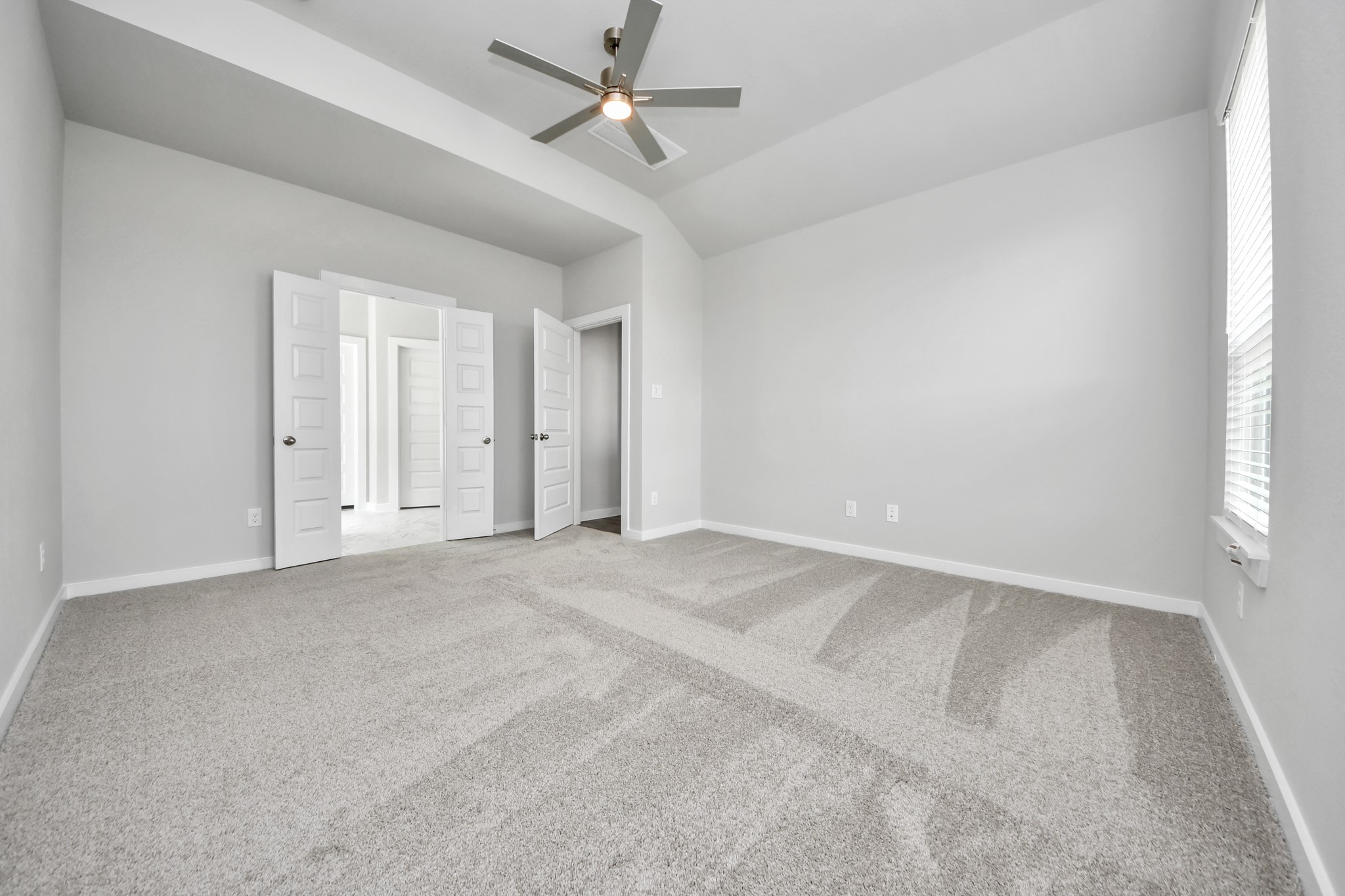 Come and unwind after a long day in this magnificent primary suite! This spacious room features plush carpet, warm paint, high ceilings and large windows with privacy blinds. Sample photo of completed home with similar floor plan. Actual colors and selections may vary.