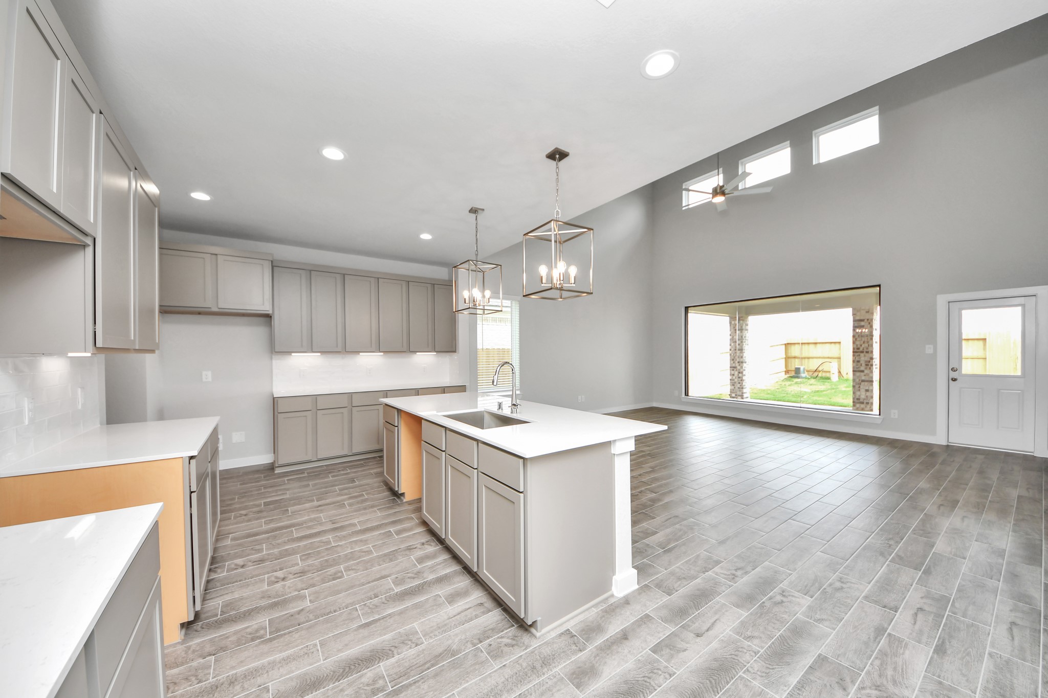 The kitchen is a culinary haven, featuring granite countertops, a tile backsplash, stainless steel appliances, 42 upper cabinets, and undercabinet lighting. Sample photo of completed home with similar floor plan. Actual colors and selections may vary.