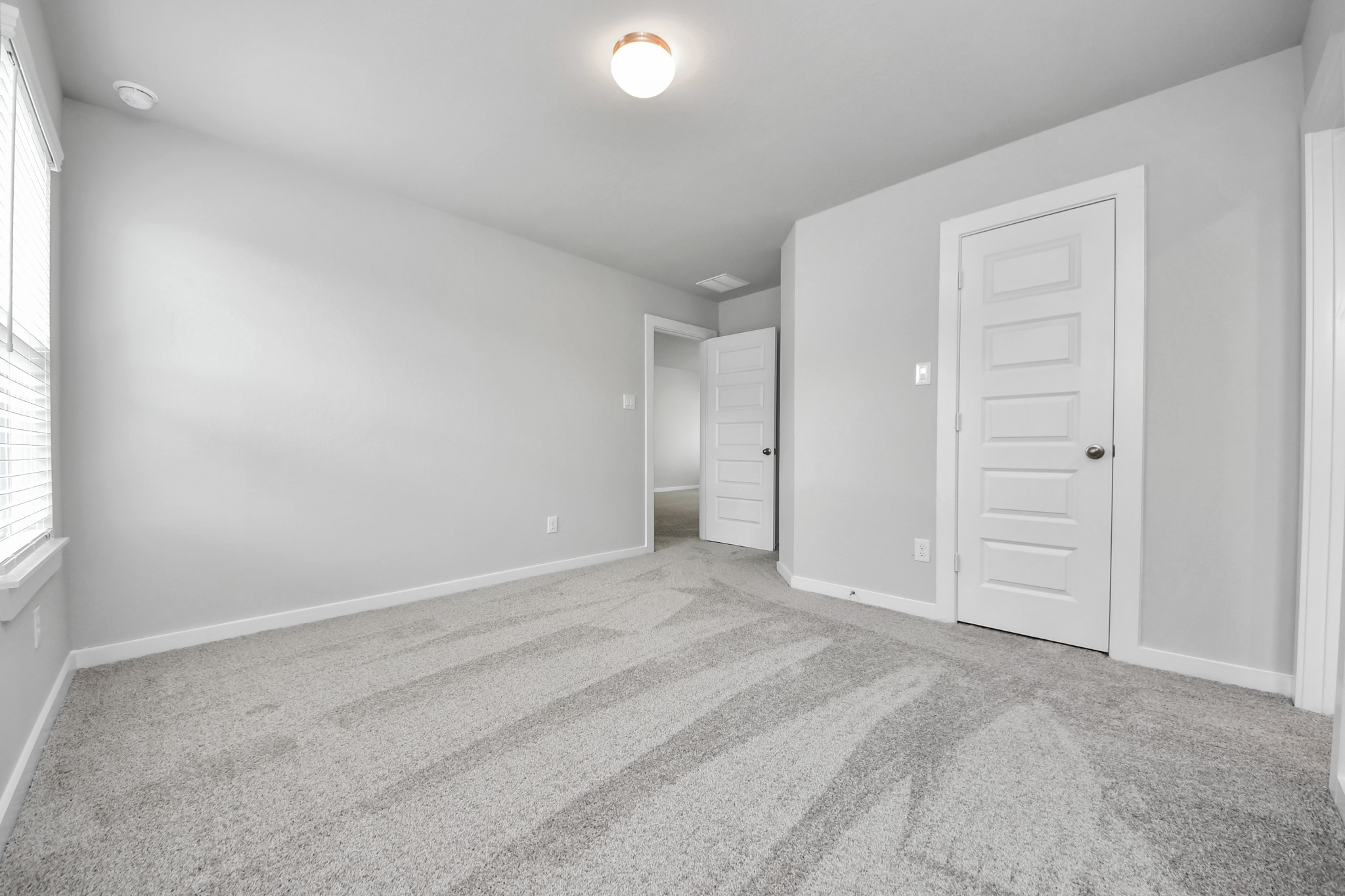 Generously sized secondary bedrooms featuring spacious closets, soft and inviting carpeting underfoot, large windows allowing plenty of natural light, and the added touch of privacy blinds for your personal retreat. Sample photo of completed home with similar floor plan. Actual colors and selections may vary.