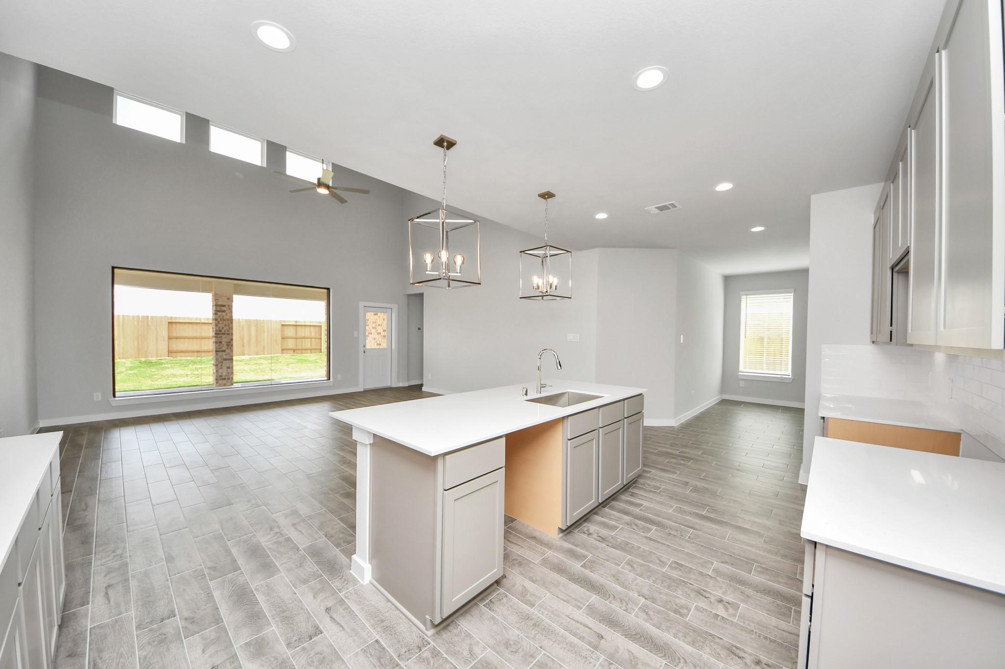 All of this overlooks your expansive family room, creating a perfect space for culinary delights and family gatherings. Sample photo of completed home with similar floor plan. Actual colors and selections may vary.
