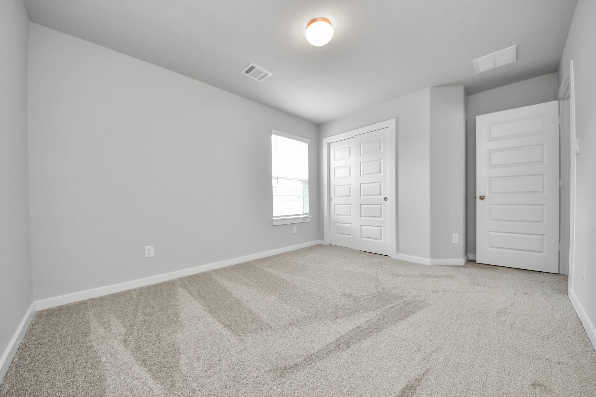 Generously sized secondary bedrooms featuring spacious closets, soft and inviting carpeting underfoot, large windows allowing plenty of natural light, and the added touch of privacy blinds for your personal retreat. Sample photo of completed home with similar floor plan. Actual colors and selections may vary.