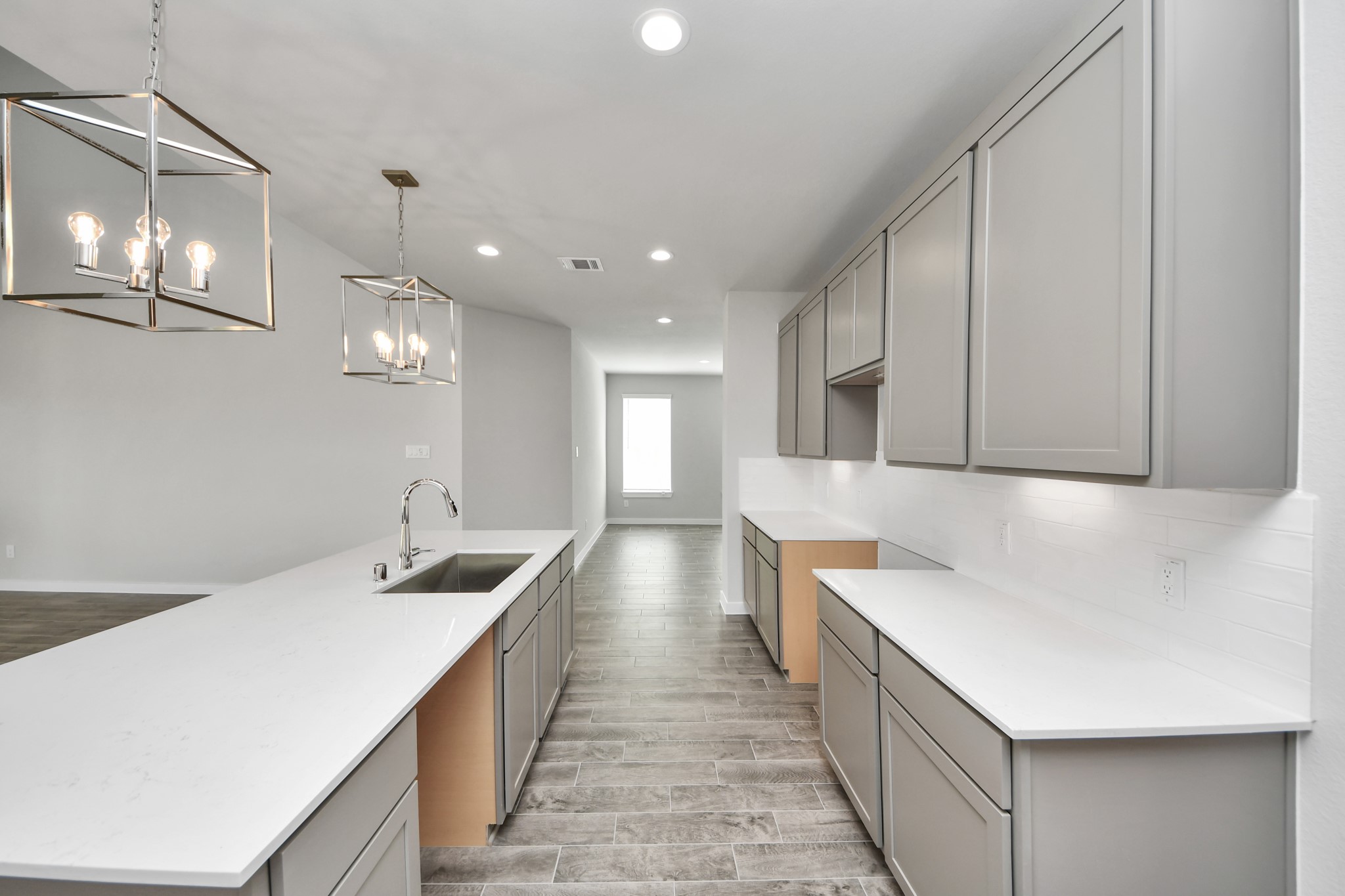 The open concept effortlessly connects the kitchen to the expansive family room, forming a perfect hub for gatherings. This seamless flow creates an inviting space where cooking and socializing come together harmoniously. Sample photo of completed home with similar floor plan. Actual colors and selections may vary.