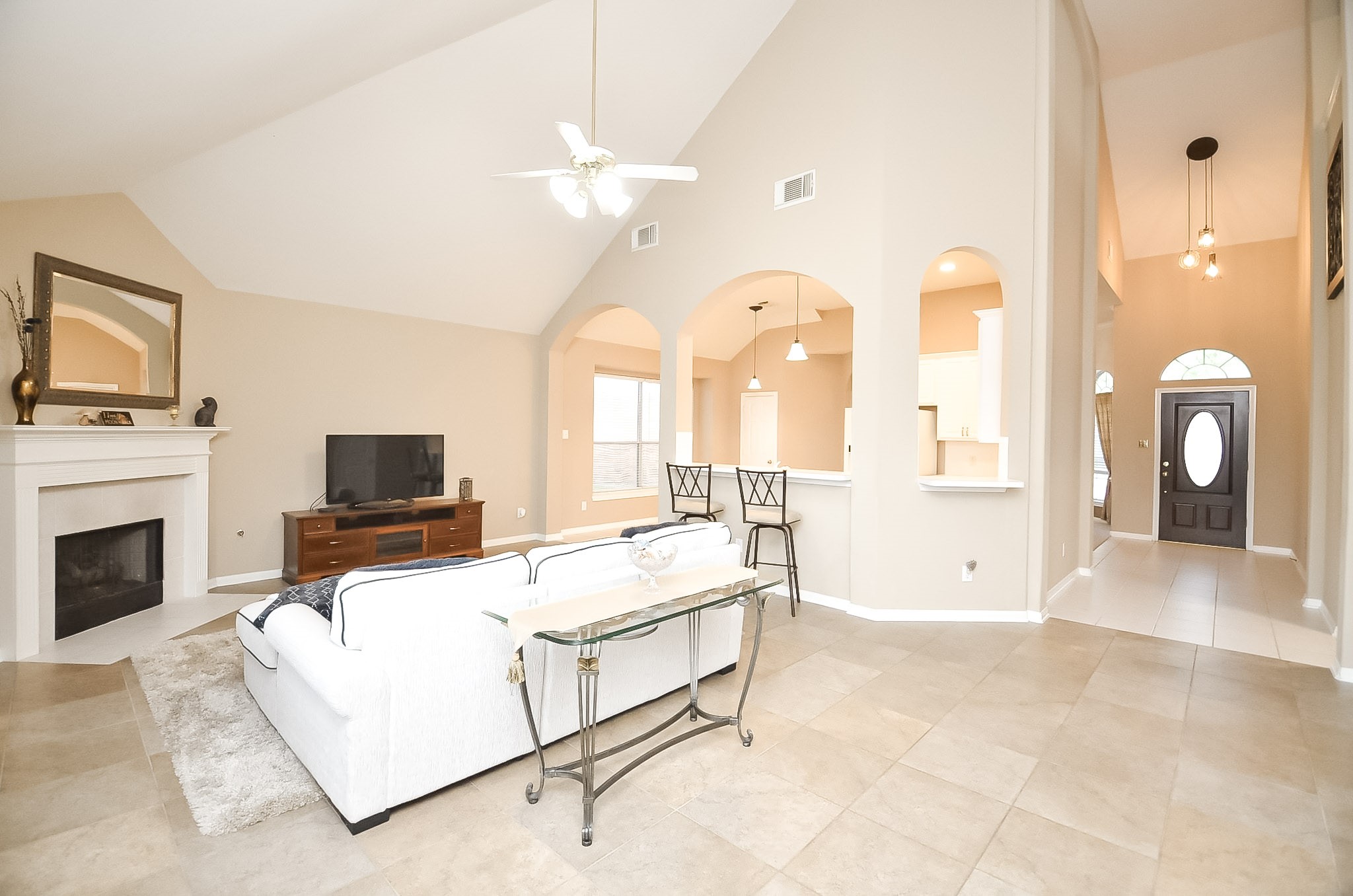 Vaulted ceiling and abundant natural light enhance the family room's inviting ambiance.