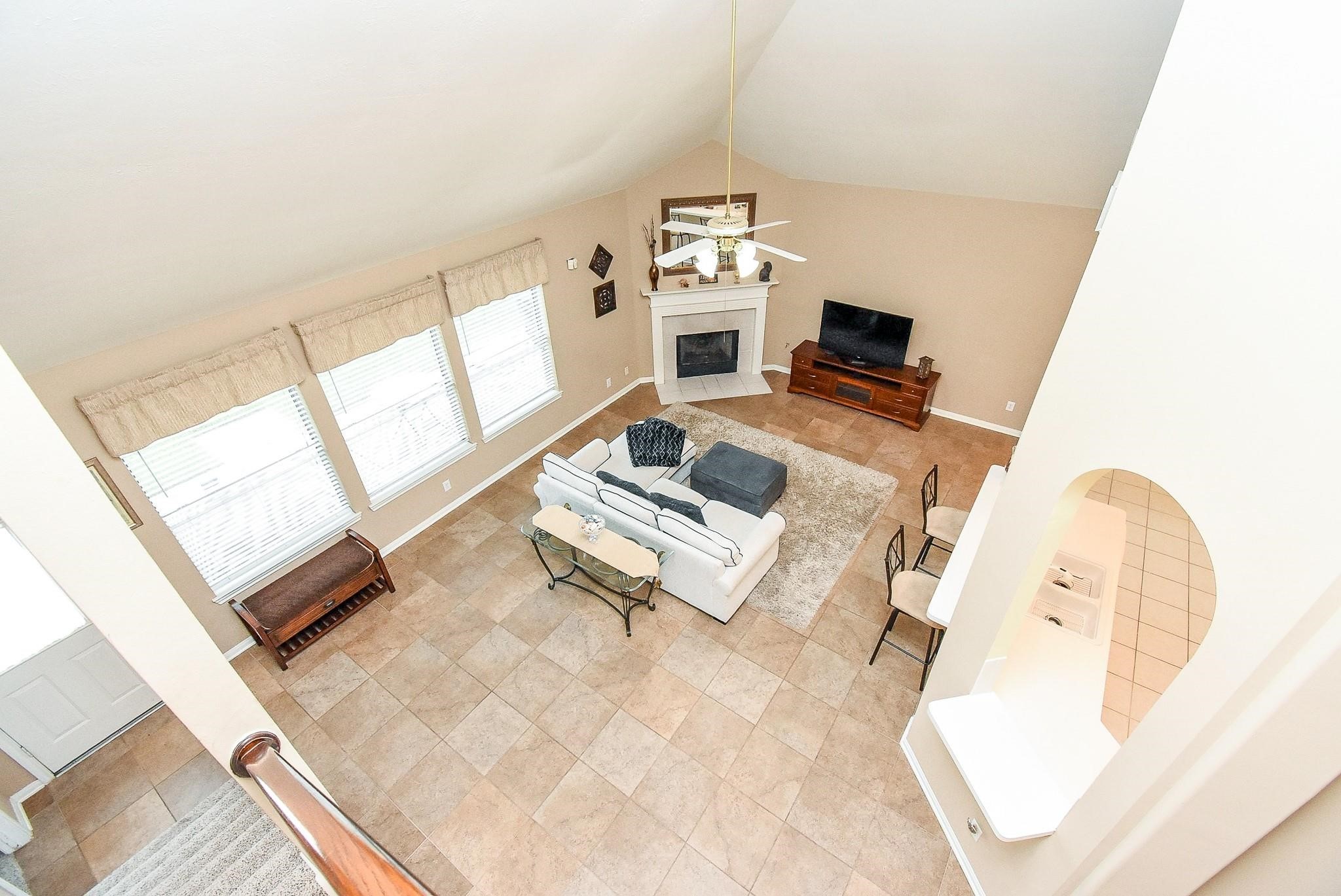 Enjoy a stunning overlook from the game room into the spacious, inviting family room below.