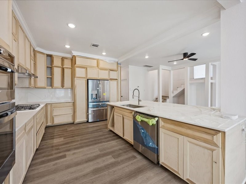 Kitchen  Spacious kitchen taking shape with custom on-site-crafted cabinetry, generous counter space, stainless-steel appliances, gas cooking, and an oversized island. Cabinetry and finish work are still underway.