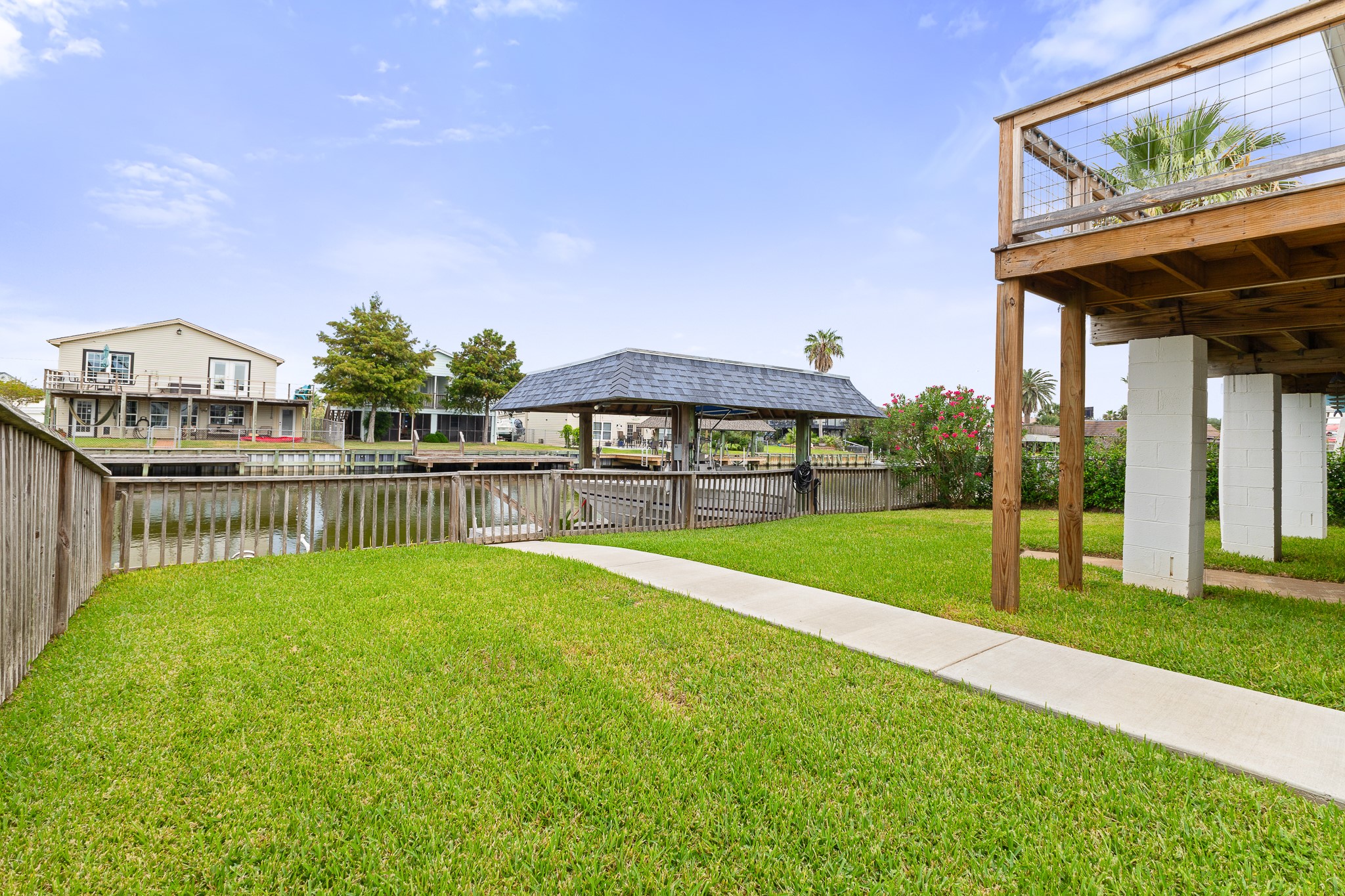Spacious fenced canal-front yard