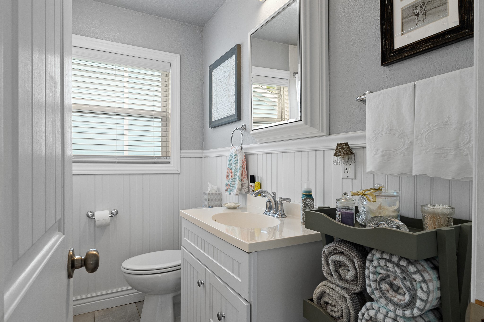 Full bathroom with tub/shower combination and window for natural light.