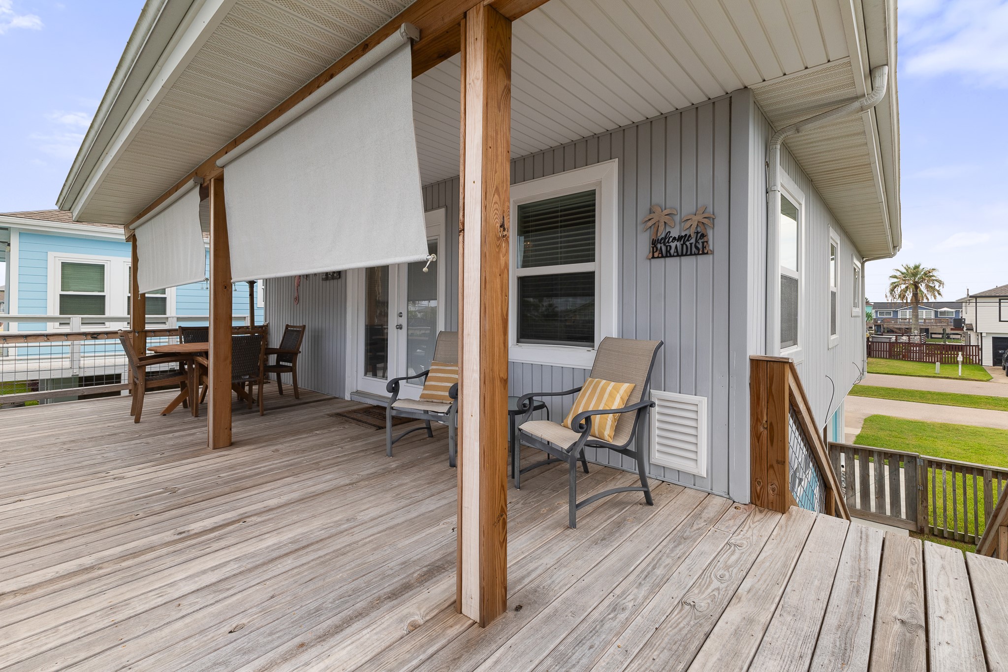 Covered deck with roll-down shades for added comfort and shade.