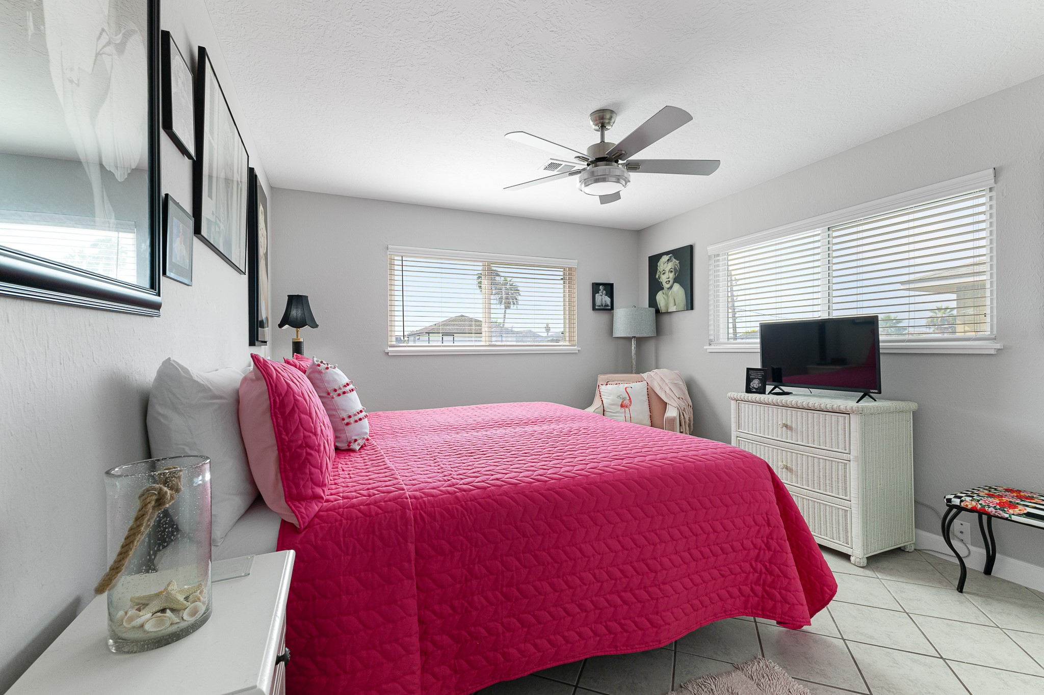 Spacious bedroom with abundant natural light from multiple windows. Spacious bedroom with abundant natural light from multiple windows.